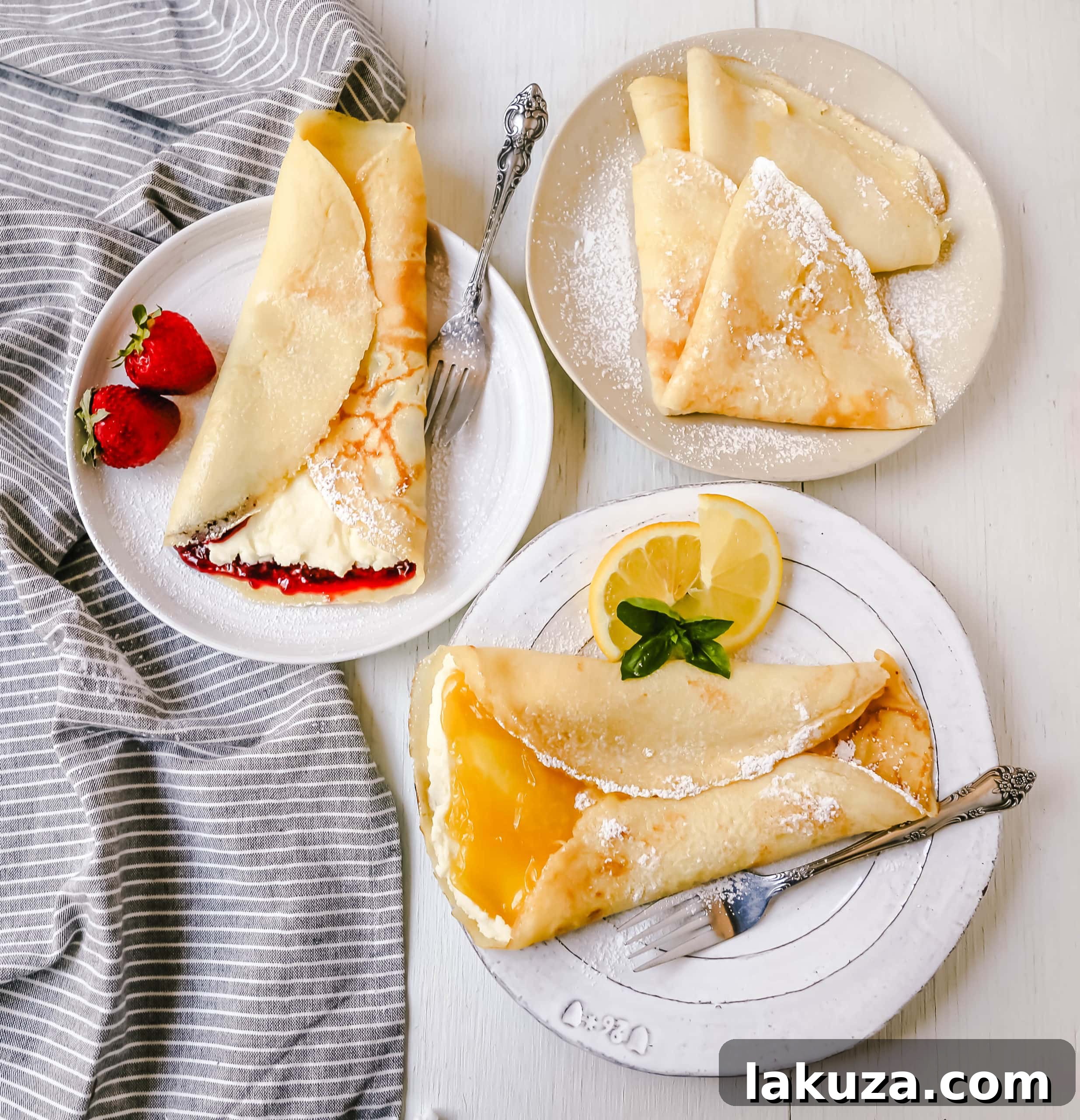 A stack of golden crepes on a rustic plate, topped with berries and mint.