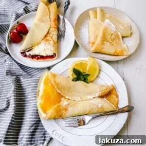 A beautifully plated stack of homemade crepes, garnished with fresh fruit and maple syrup, capturing the essence of a perfect breakfast.