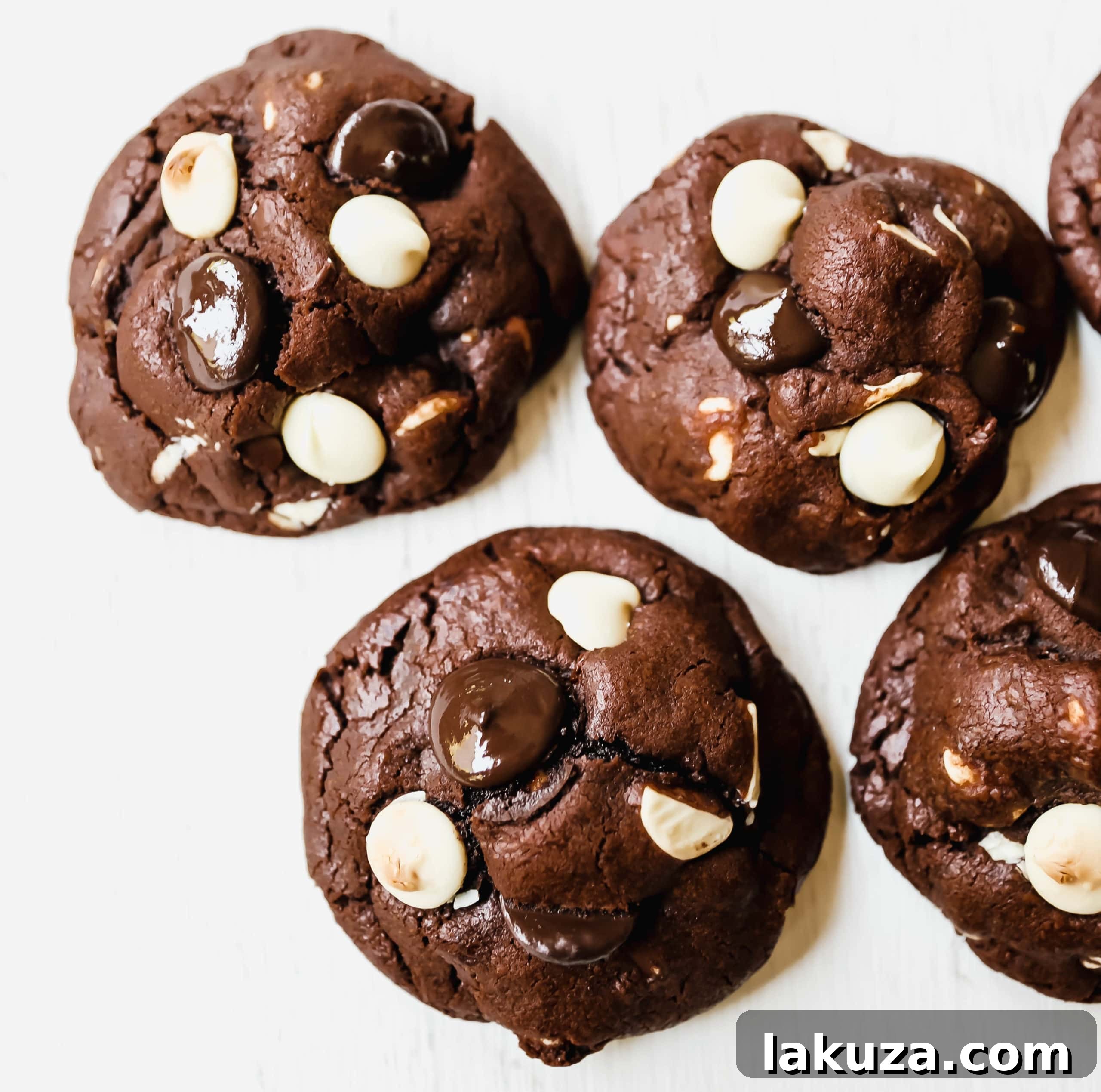 A close-up shot of a stack of freshly baked Bakery-Style Chocolate White Chocolate Chip Cookies, highlighting their gooey melted chocolate.