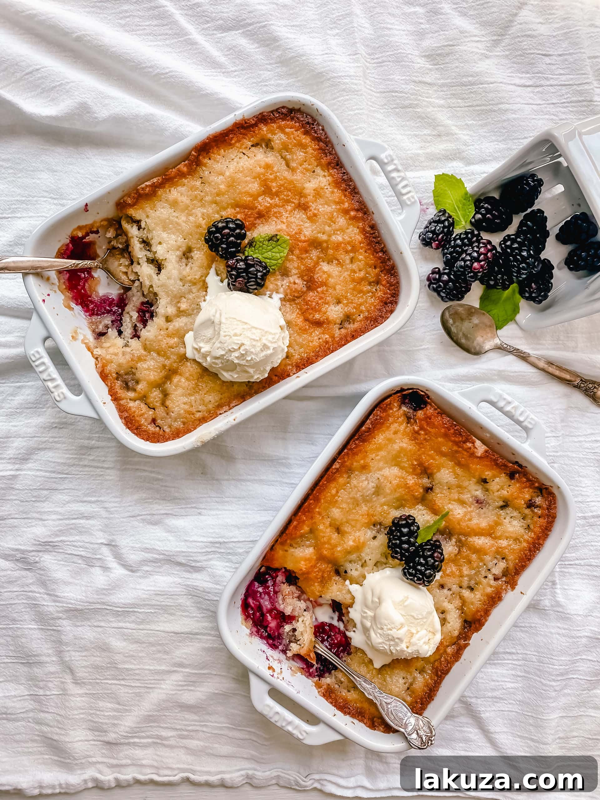 Homemade Blackberry Cobbler baking in a dish, showing the rising crust.