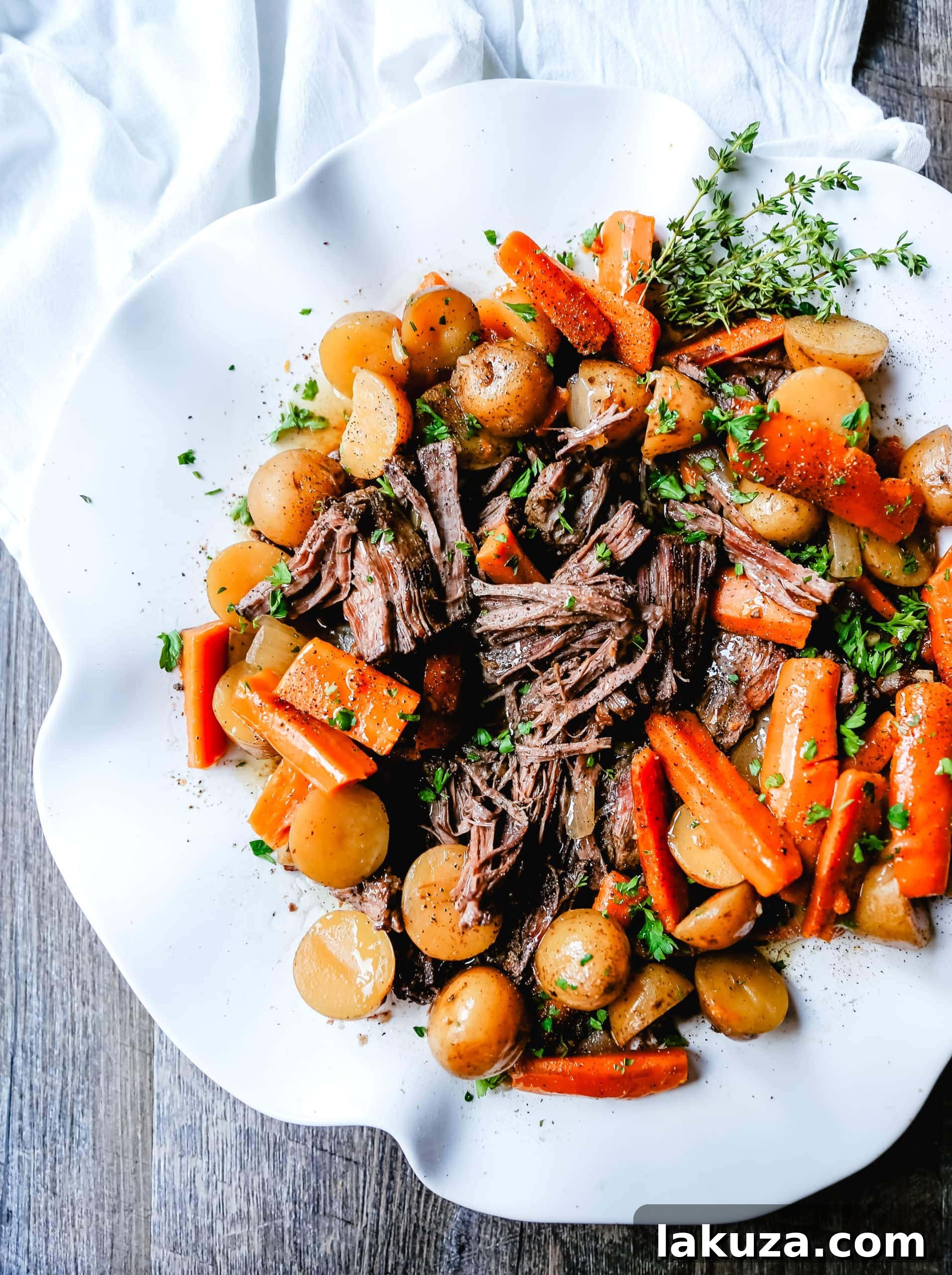 Tender, slow-cooked, and deeply flavorful beef pot roast with perfectly golden potatoes and savory carrots. The ultimate guide to making an incredibly moist and succulent pot roast at home.