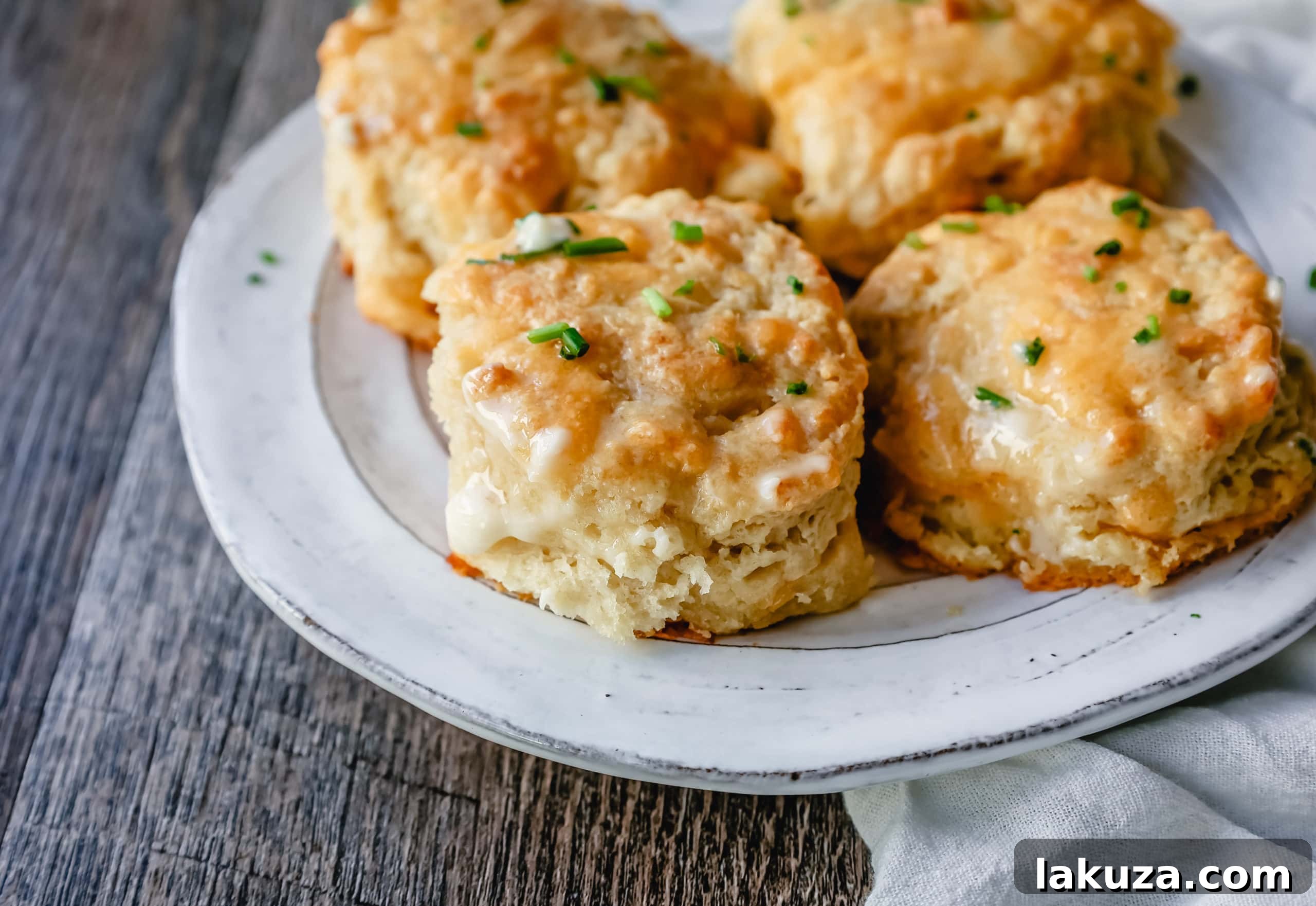 Freshly baked homemade cheesy garlic biscuits arranged closely in a baking dish, ready to be served.