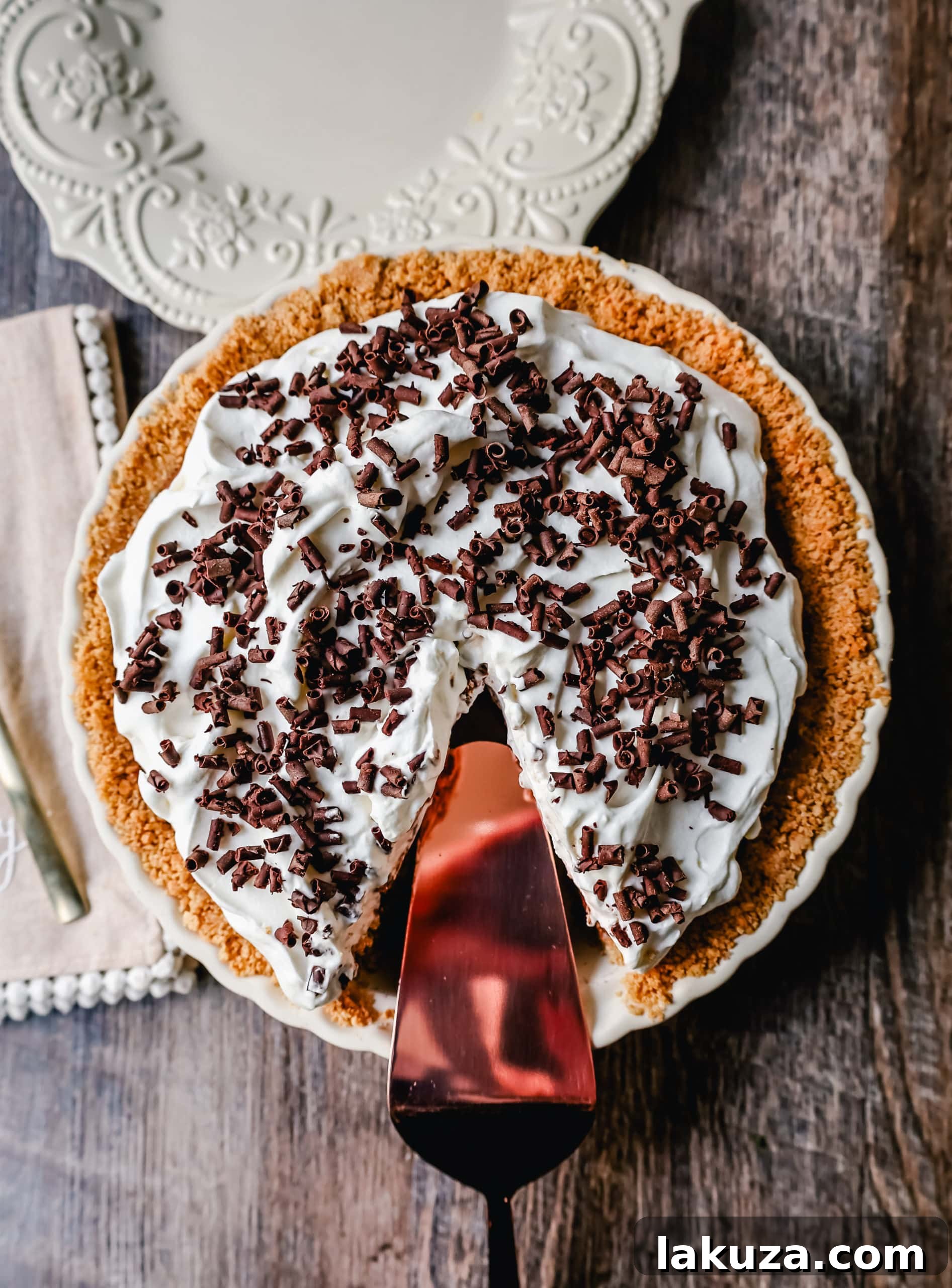 A large slice of French Silk Pie, showcasing its irresistible layers of chocolate and whipped cream, inviting you to take a bite.