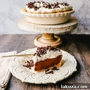 French Silk Pie: Rich, creamy chocolate cream topped with fresh whipped cream and chocolate shaving all in a buttery graham cracker crust.
