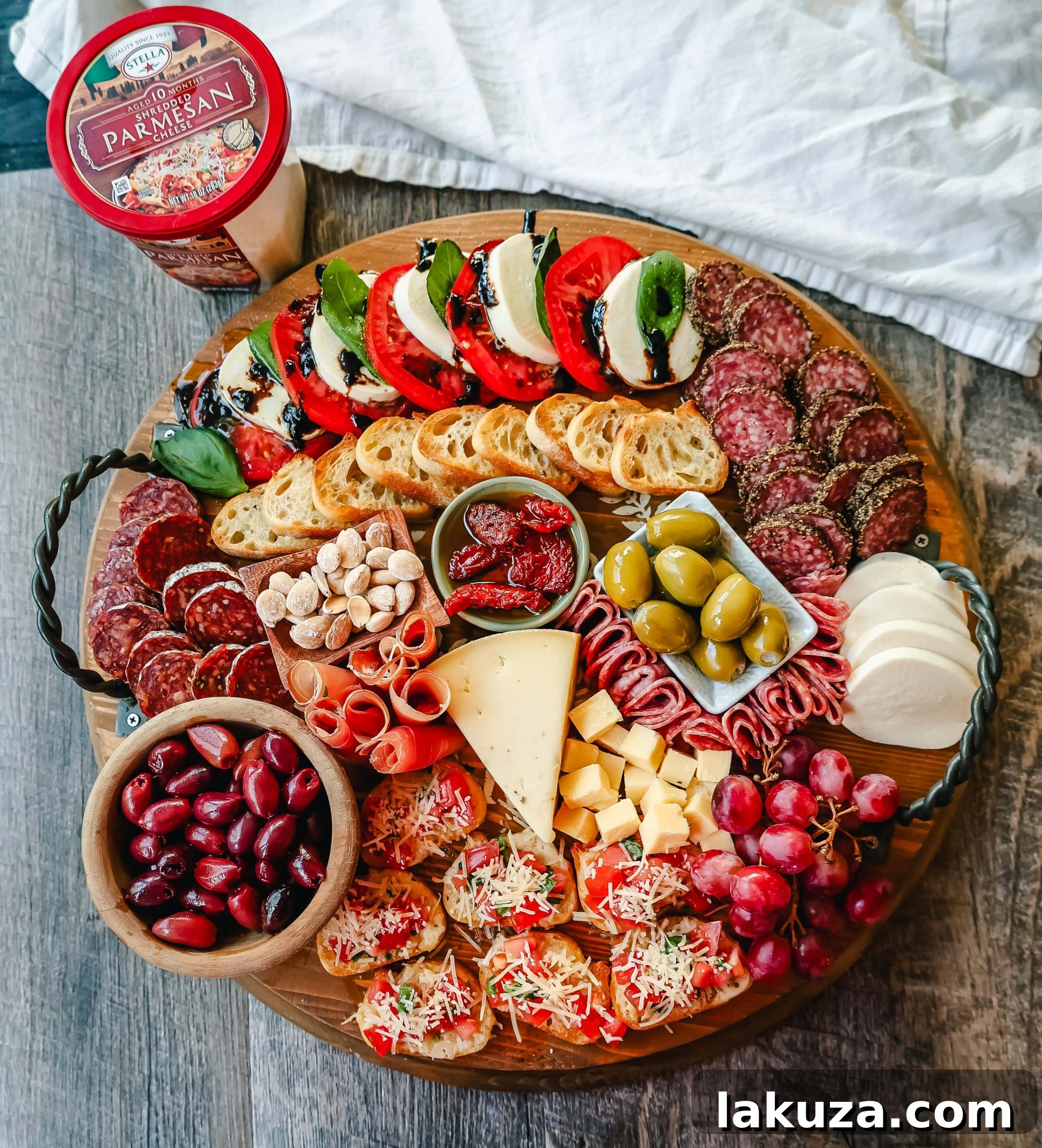 An exquisitely arranged Italian Charcuterie board featuring a generous selection of Italian cured meats, artisan cheeses, olives, grapes, and various gourmet condiments, perfect for an authentic Italian spread.