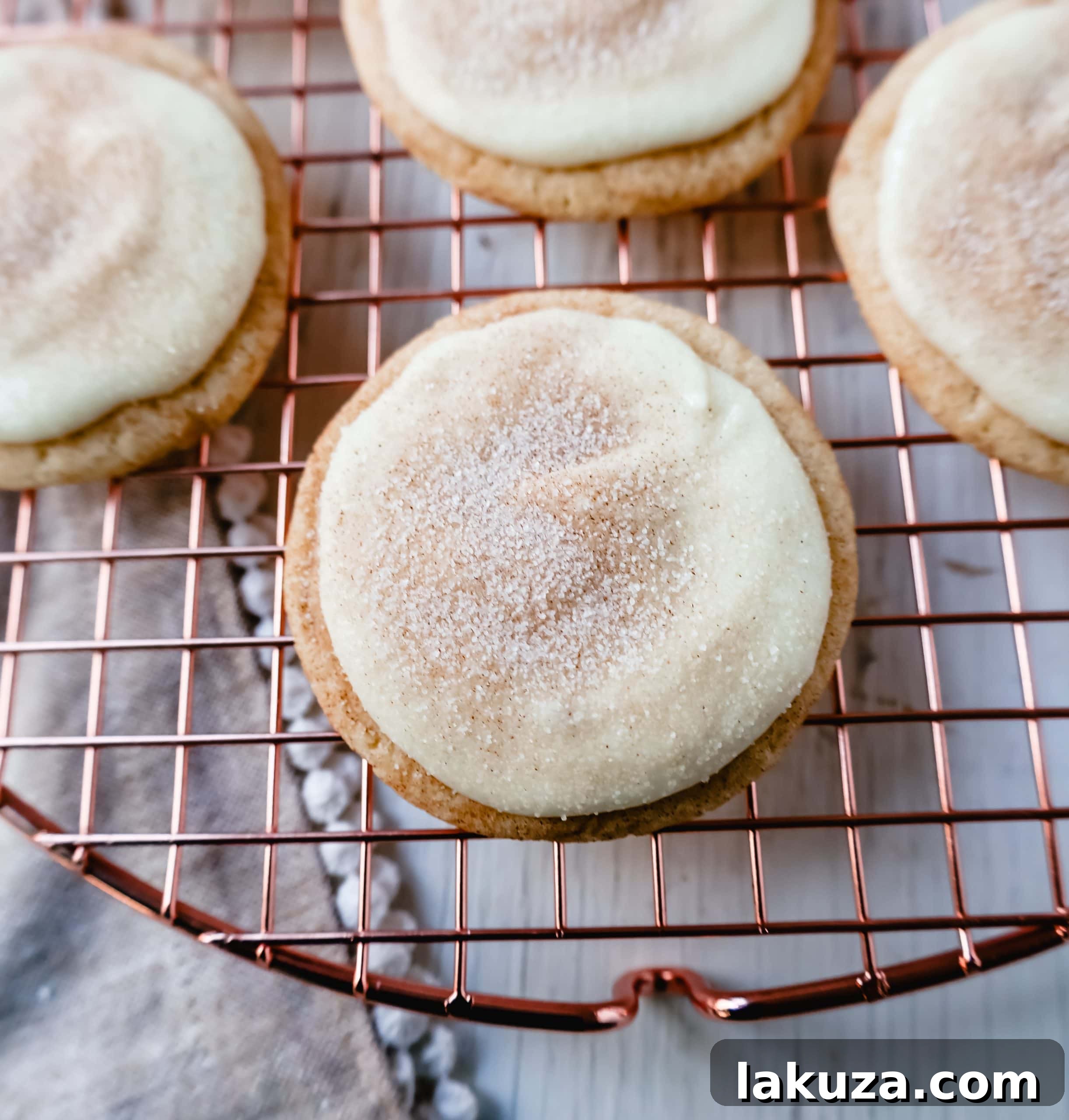 Delicious Frosted Snickerdoodle Cookies with cream cheese frosting and cinnamon sugar sprinkle, perfect for holiday baking