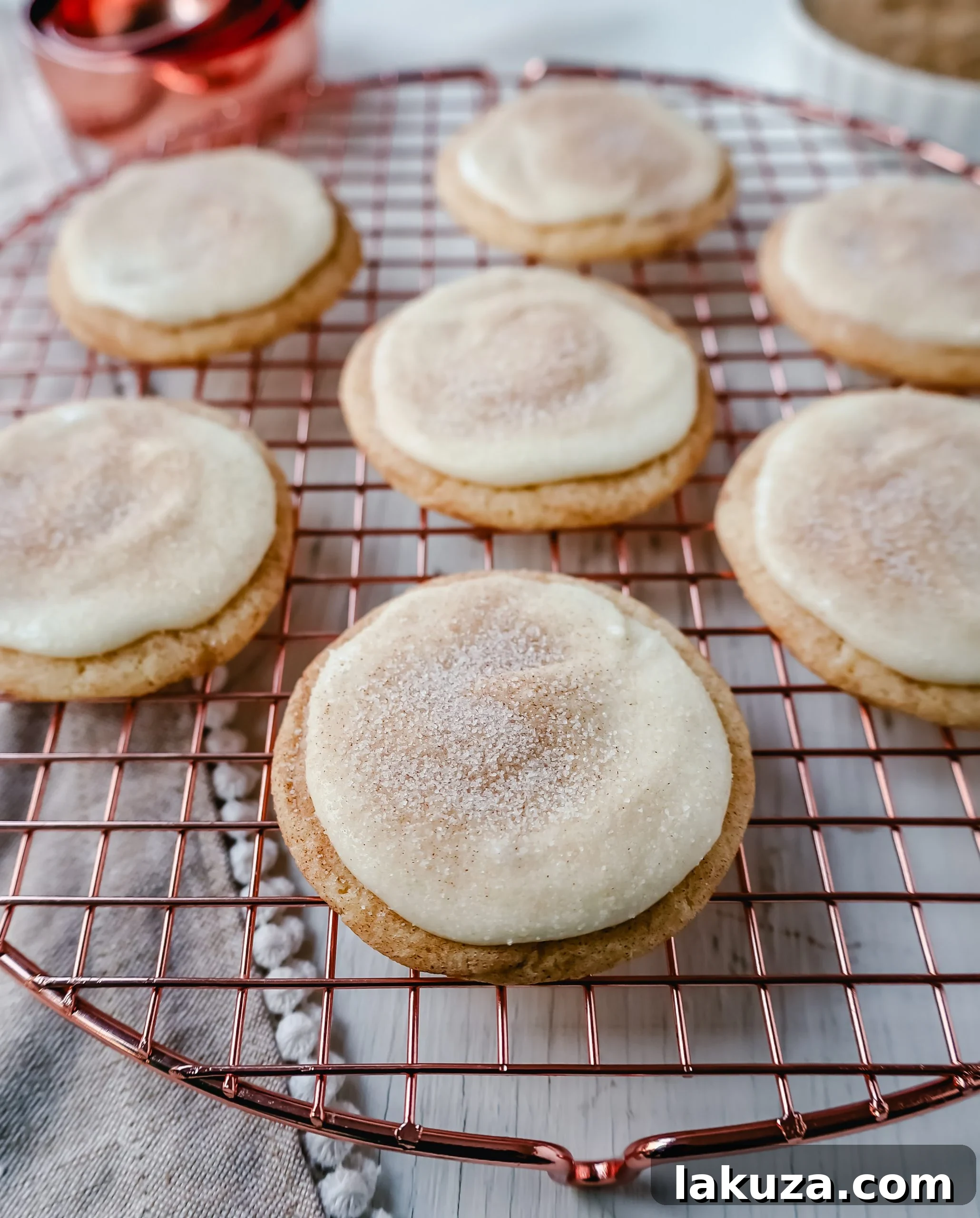 Batch of freshly baked Frosted Snickerdoodle Cookies cooling on a wire rack