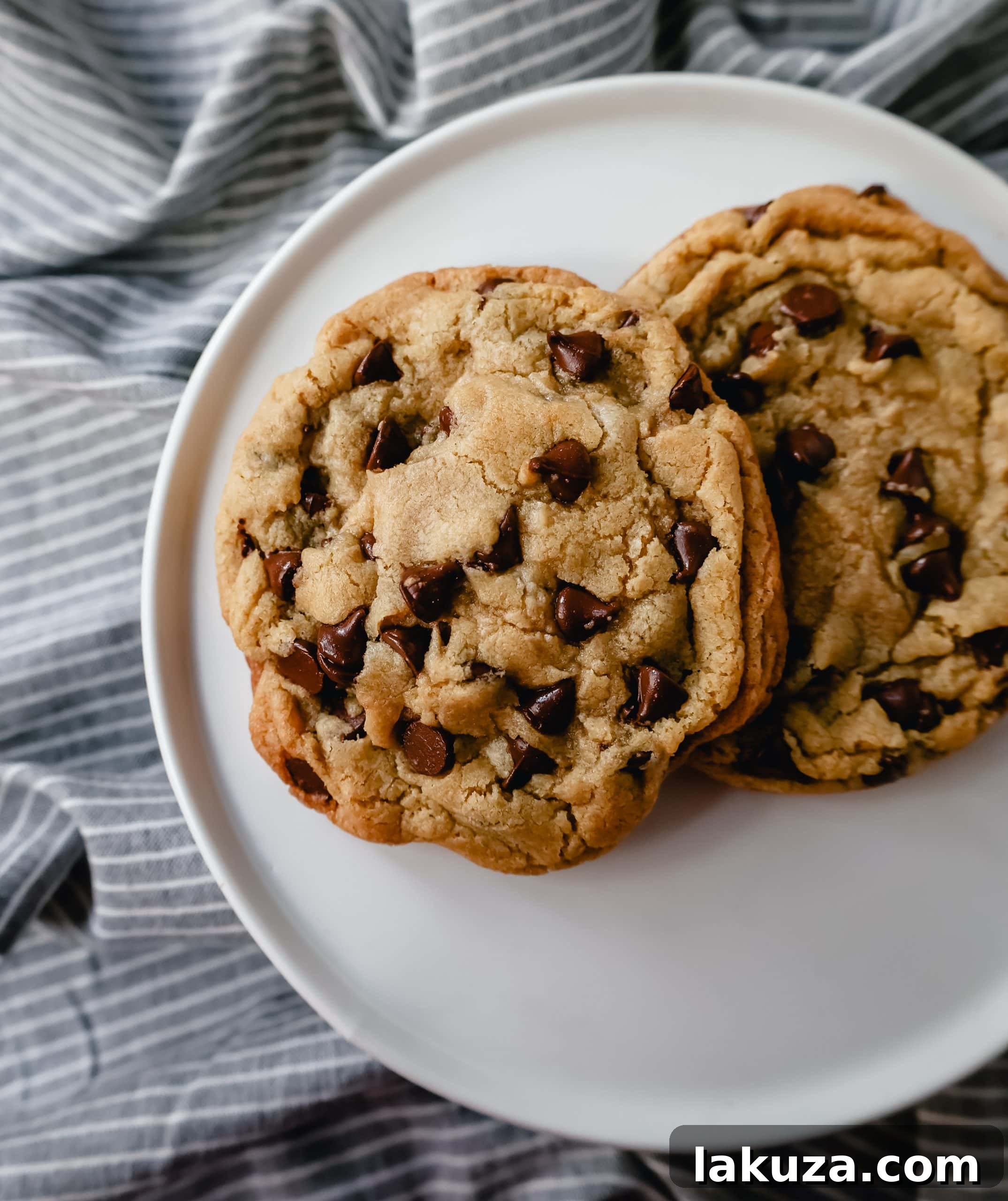 Sweetheart Chocolate Chip Cookies for Two 4 Stack of two golden brown chocolate chip cookies, showing their soft centers and crispy edges.