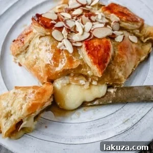 Golden Honey Almond Baked Brie 6 Honey Almond Puff Pastry Wrapped Brie, a delightful and easy party appetizer
