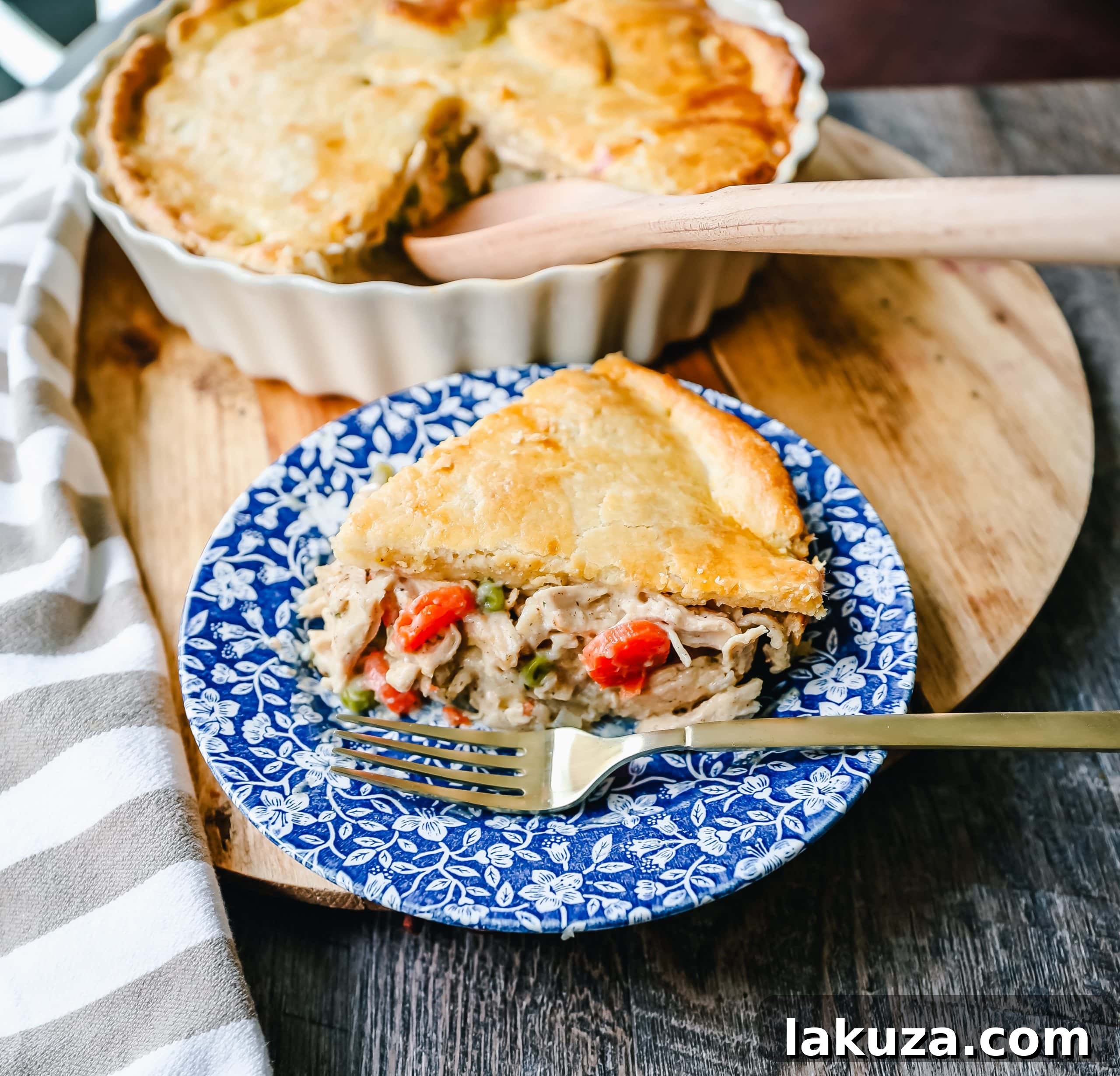 A close-up of a rustic Chicken Pot Pie, showcasing its golden crust and delicious creamy filling with chunks of chicken and vegetables.