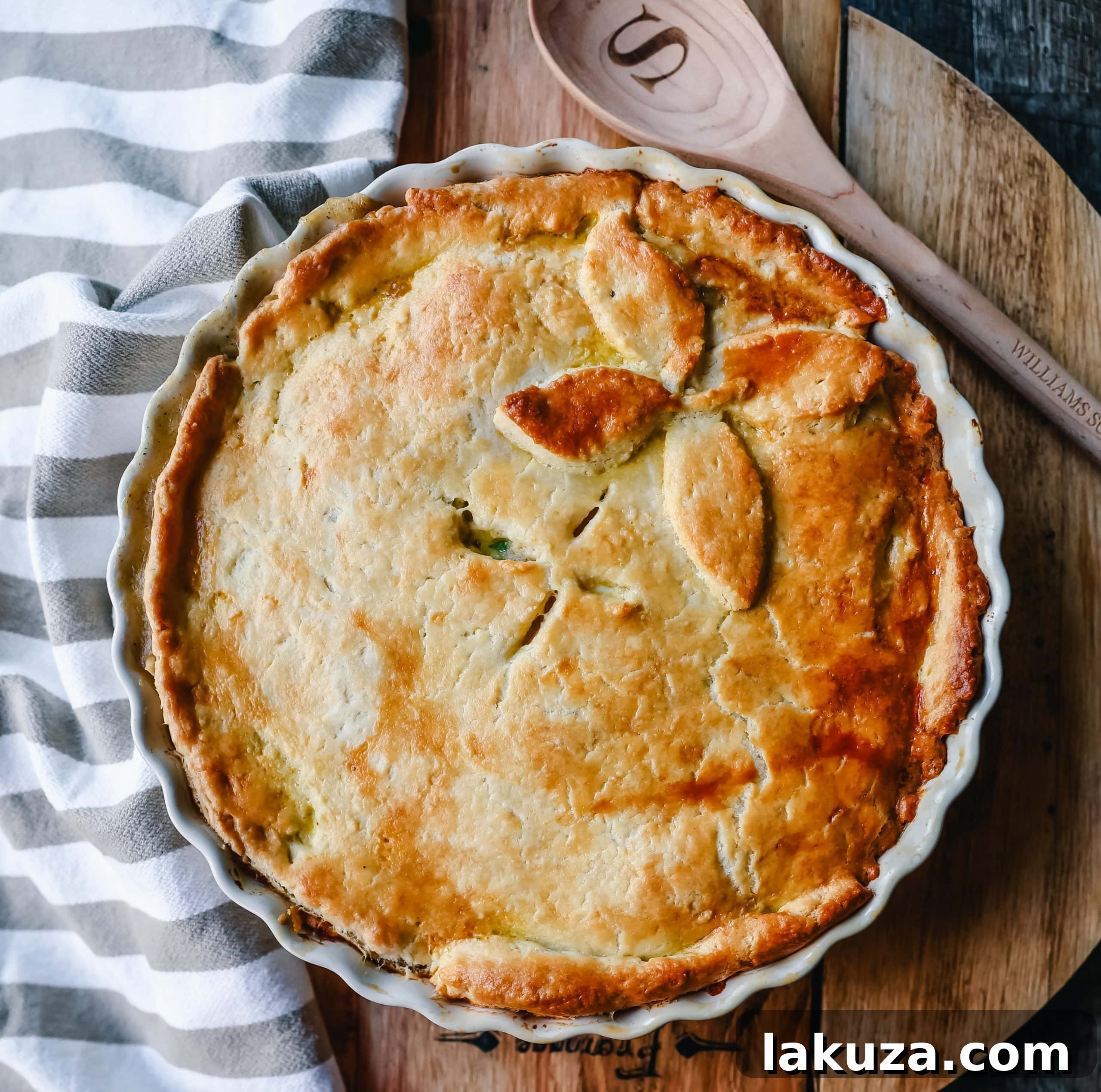 A slice of warm Homemade Chicken Pot Pie revealing its creamy interior and tender chicken and vegetables.