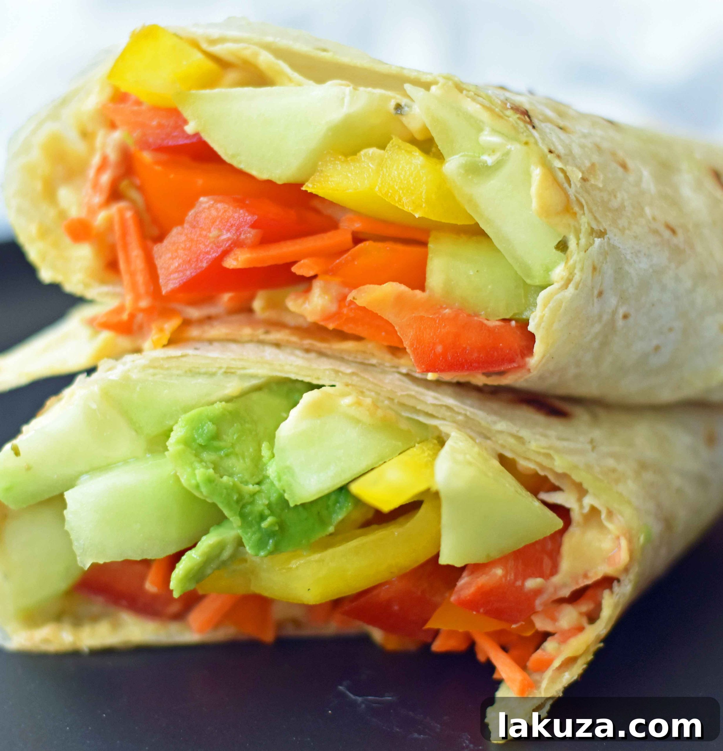 Hummus Veggie Wraps: homemade avocado ranch hummus, fresh veggies, and flour tortillas make a nutritious and appealing meal. Perfect for school or work.
