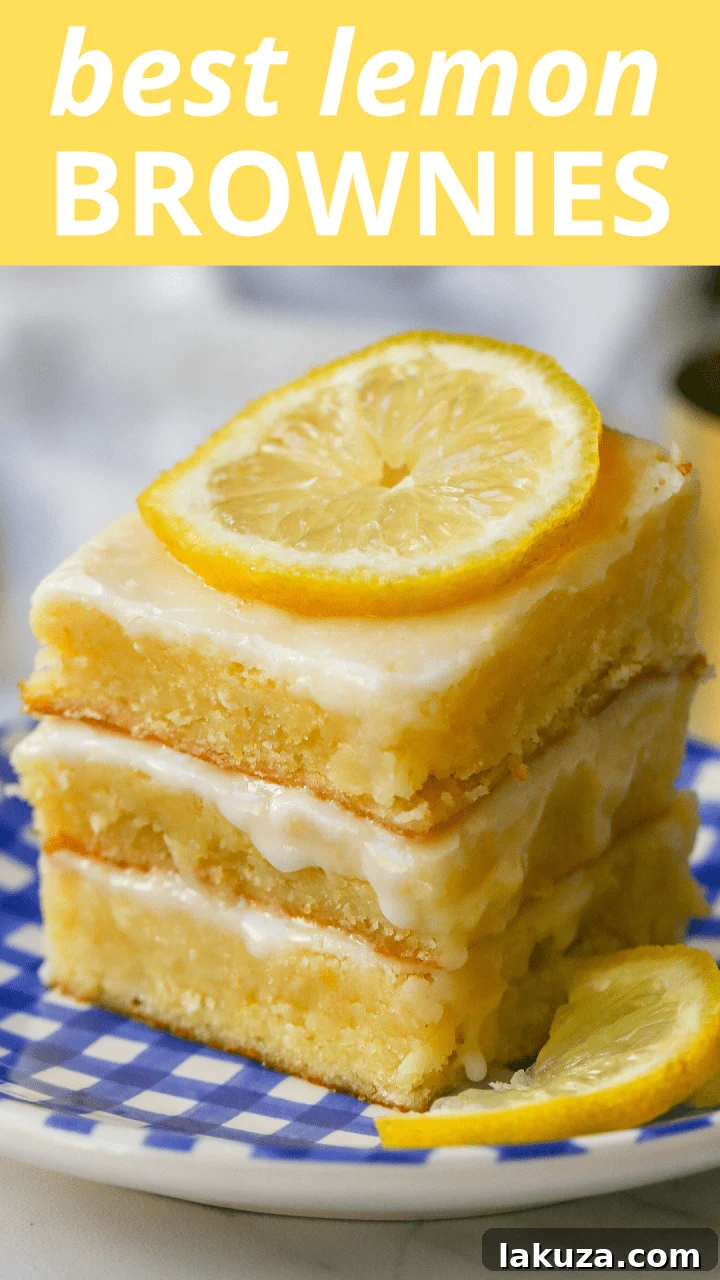 A large tray of freshly baked Lemon Brownies, uncut, showing the full spread of lemon glaze