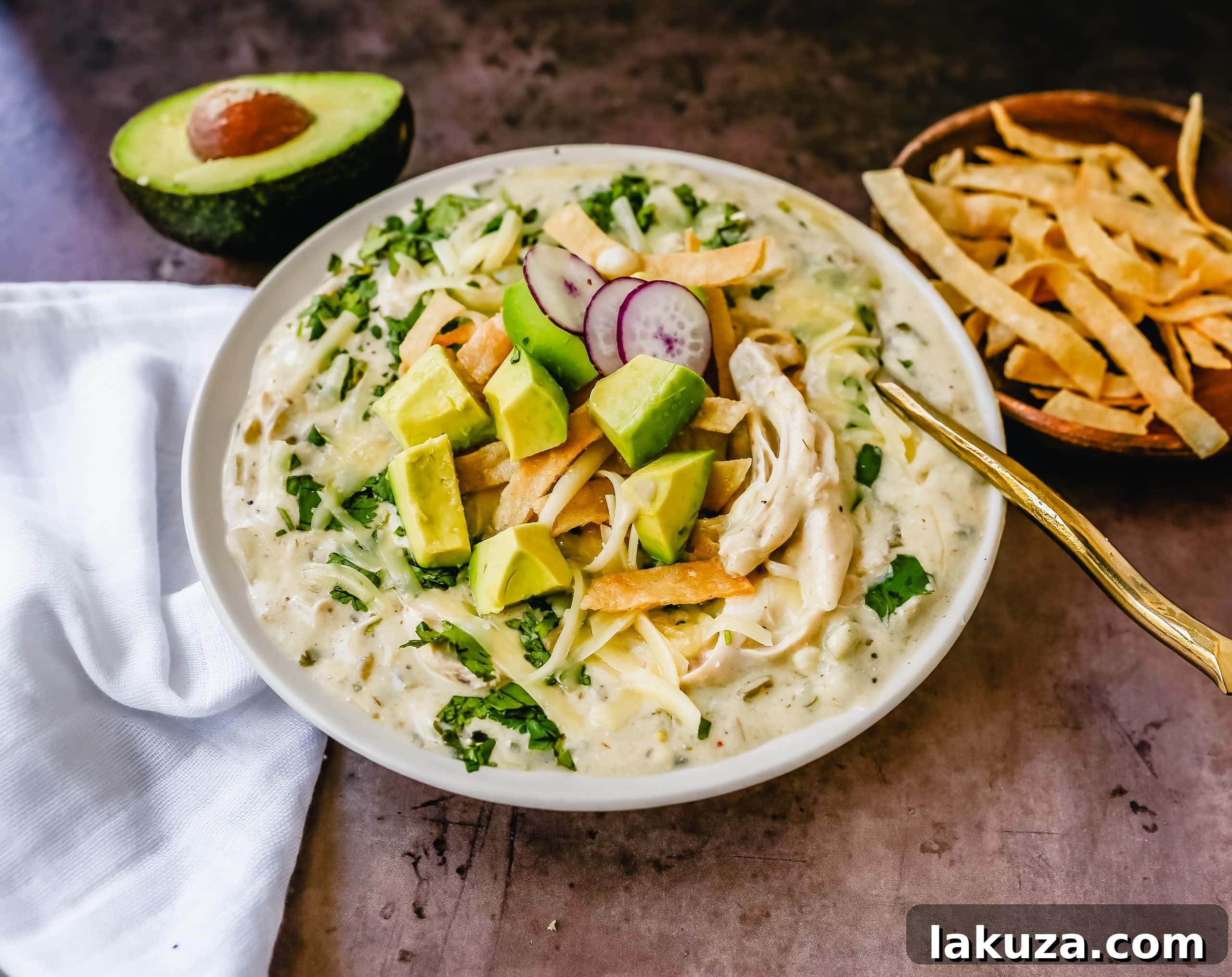 Hearty Southwestern Chicken Enchilada Soup 4 Closeup of Green Chile Chicken Enchilada Soup with crispy tortilla strips and cilantro.