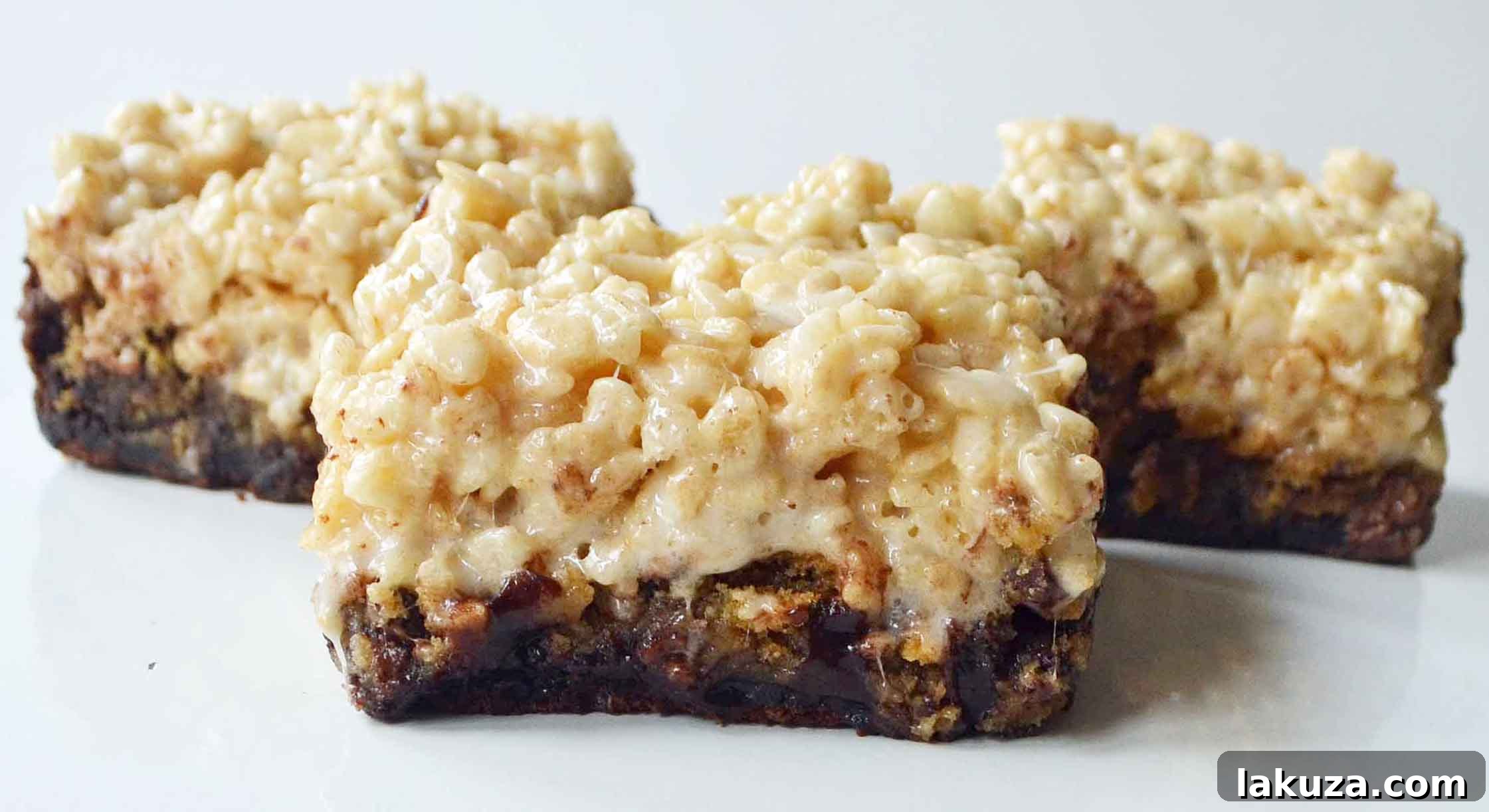 Triple Threat Bars 3 Bake Sale Trifecta Bars are a decadent chocolate brownie, classic chocolate chip cookies, and buttery soft rice krispies treat all in one. It is three favorite treats all in one bar! www.modernhoney.com