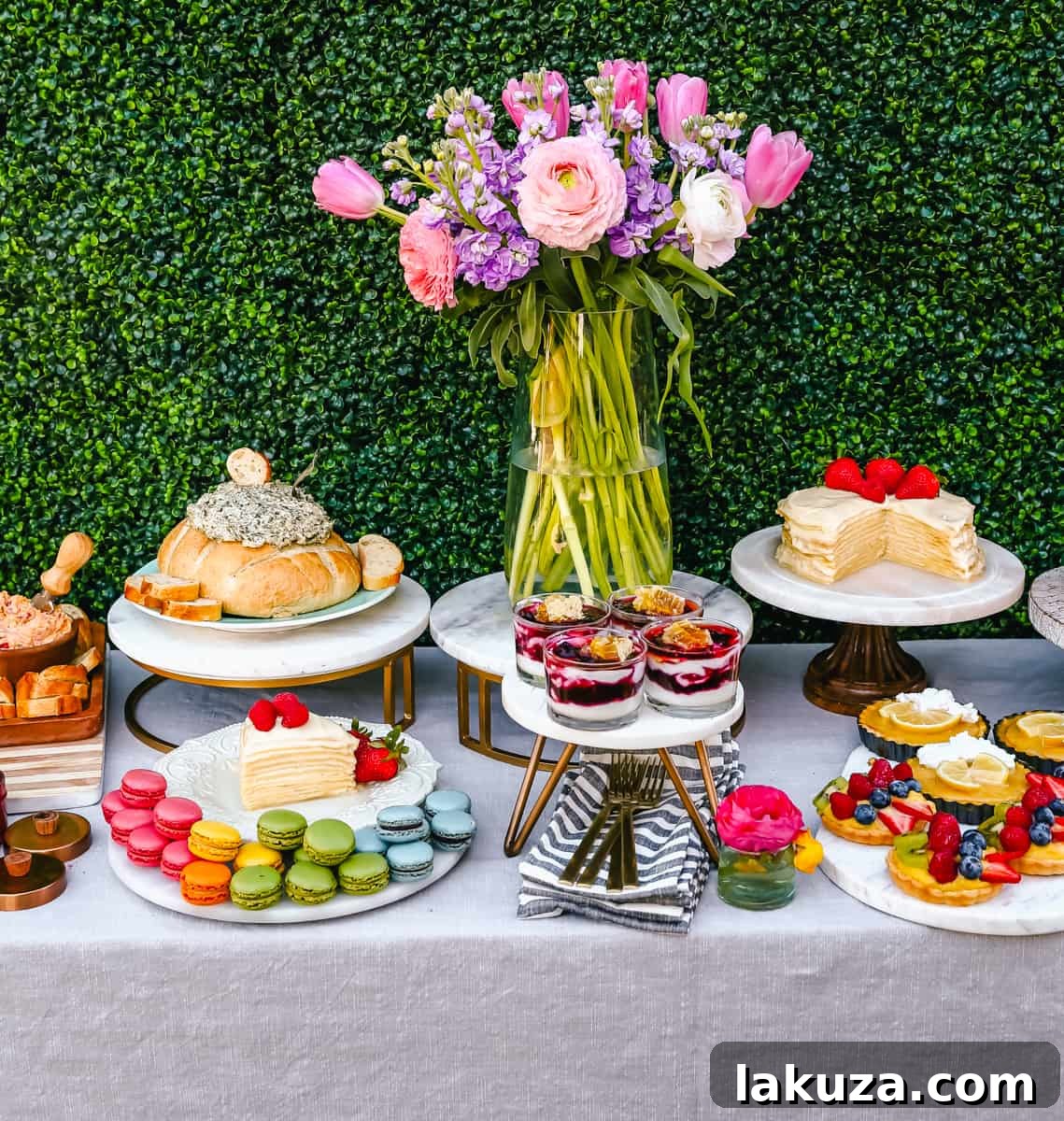 A stunning Easter dessert table adorned with cakes, tarts, and other sweet treats, set against a backdrop of spring flowers. Provides ample inspiration for creating the ultimate spring brunch dessert spread.