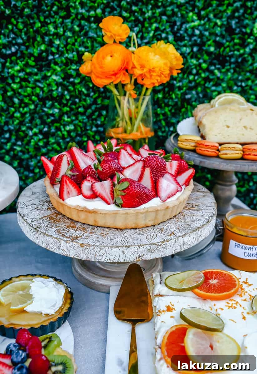 A delectable Strawberry Cream Tart, beautifully garnished with fresh strawberries, serving as a centerpiece dessert for an ultimate spring brunch or party. Highlights delicious food ideas and elegant presentation for Easter.