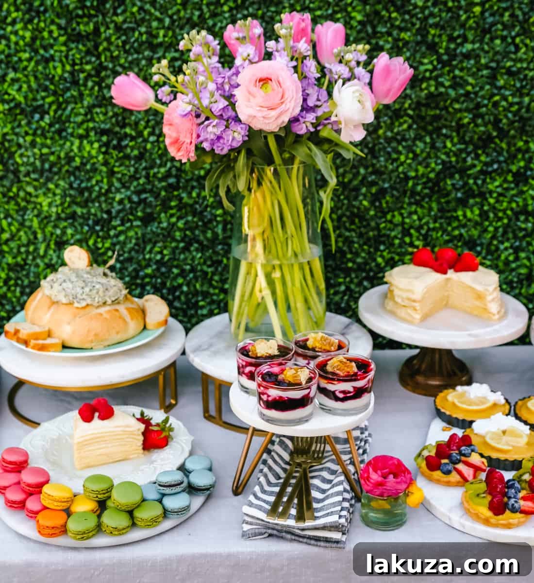 An elaborate spring brunch display featuring an assortment of sweet and savory dishes, including pastries, tarts, and fresh fruit. Highlights creative Easter party food ideas and spring decorating inspiration.