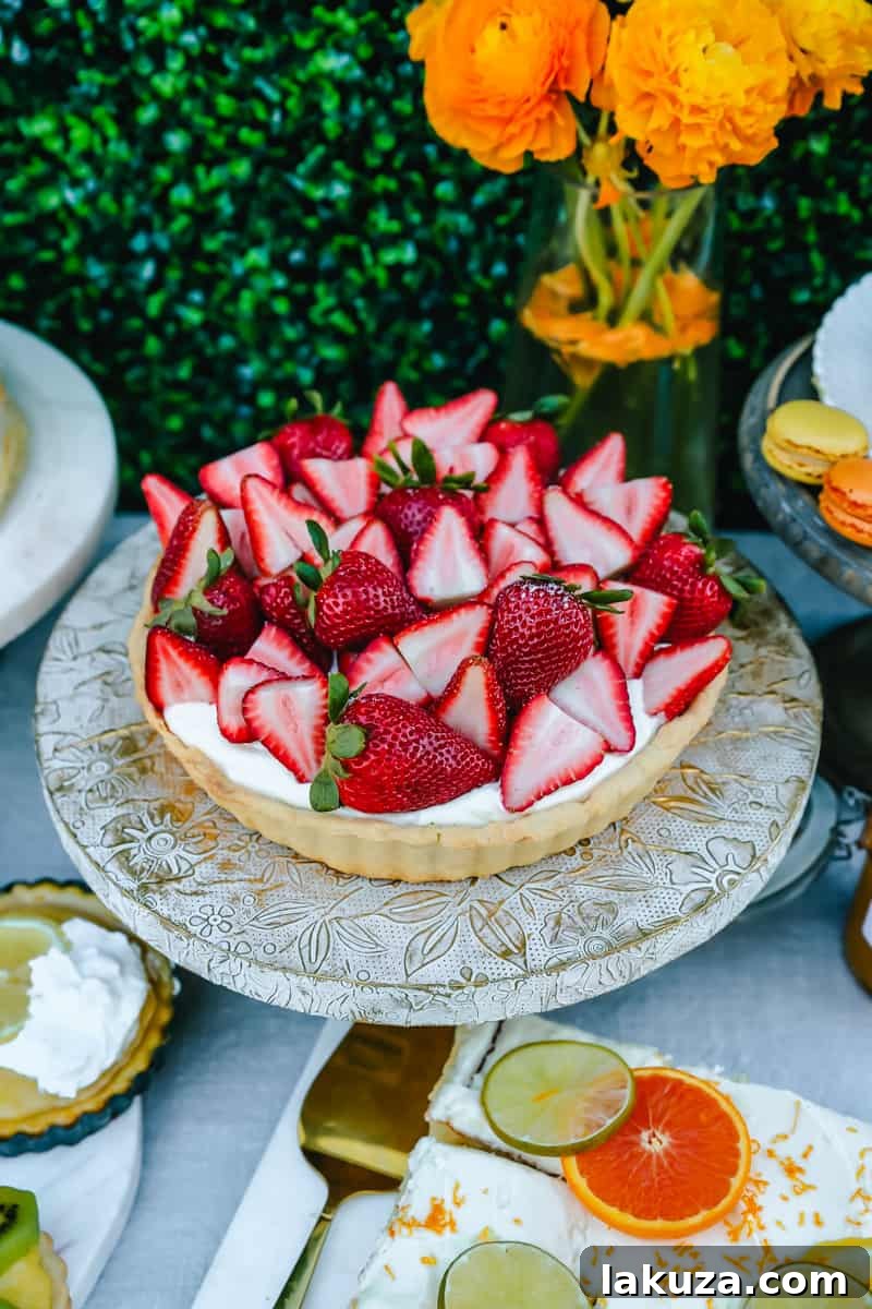 A vibrant Strawberry Tart, perfect for a spring or Easter brunch. Part of a larger spread featuring an assortment of sweet and savory breakfast items and beautiful desserts, alongside decoration ideas.