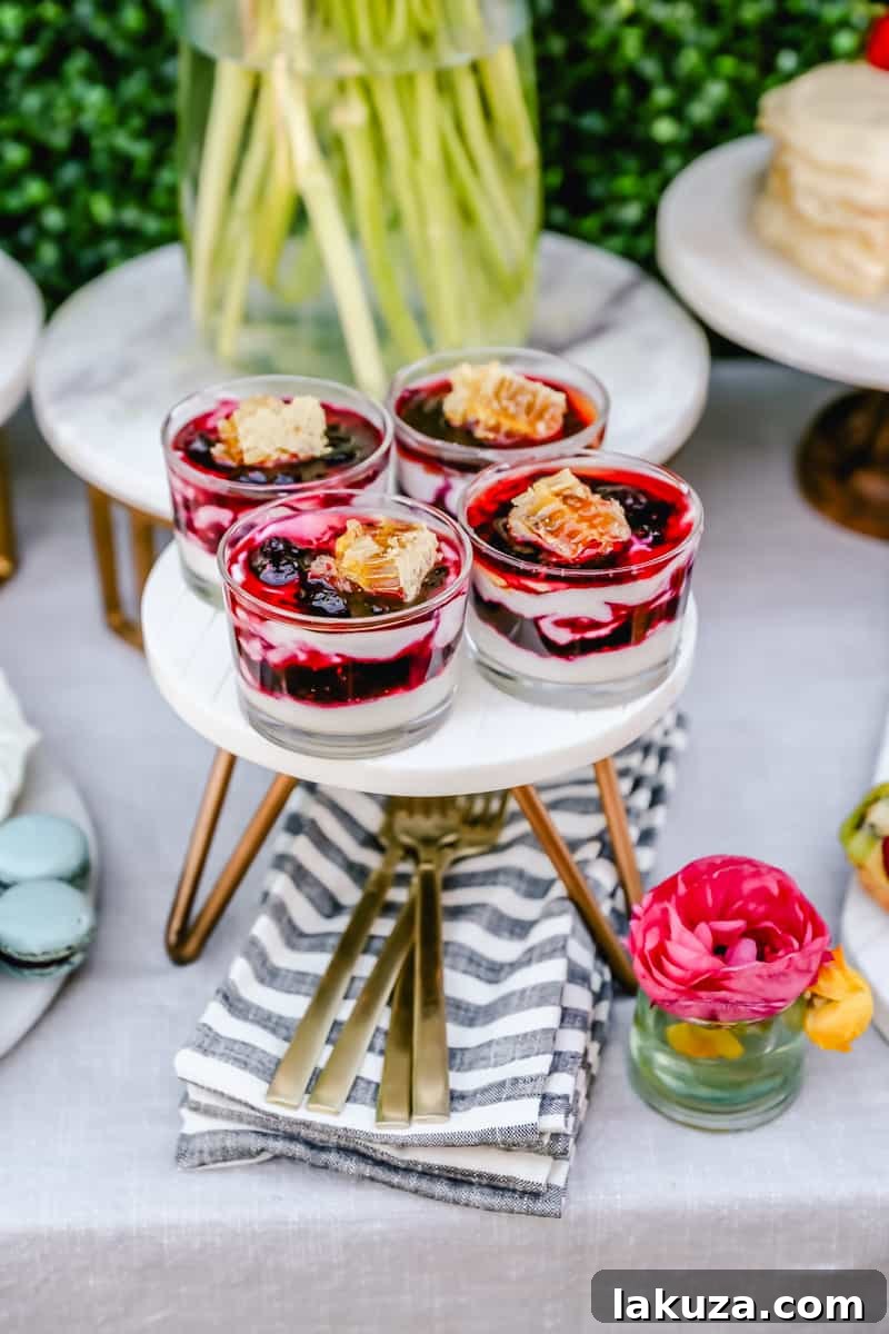 Elegant breakfast yogurt parfaits layered with berry coulis and topped with honeycomb, a perfect light and refreshing option for a spring brunch.