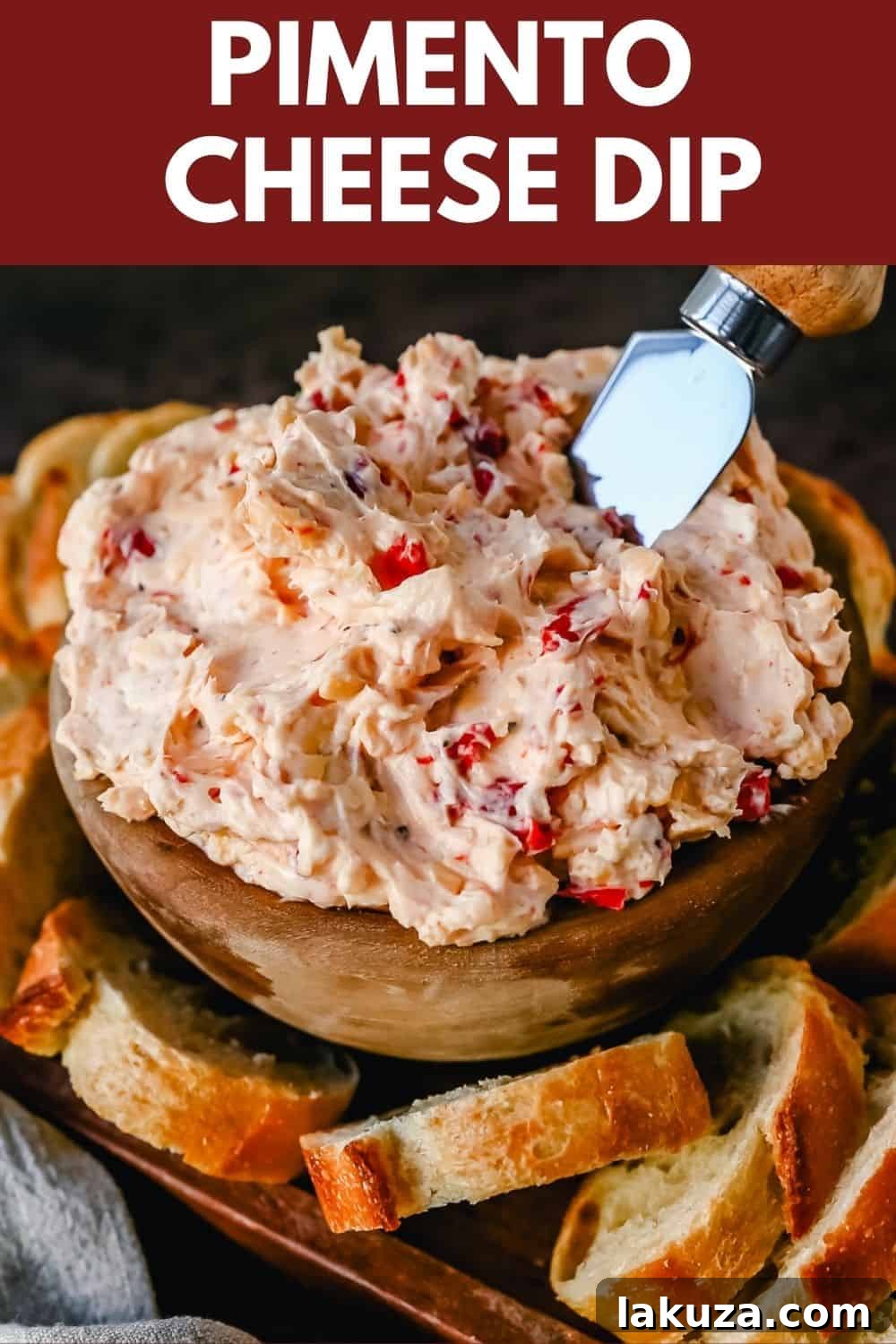 Bowl of freshly made pimento cheese dip, garnished with extra pimentos, ready for serving