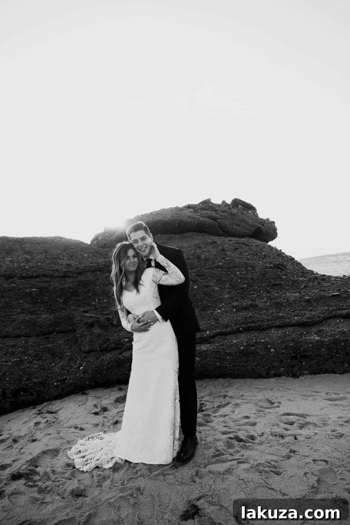 Romantic beach bridal photo of Sierra and Conner embracing