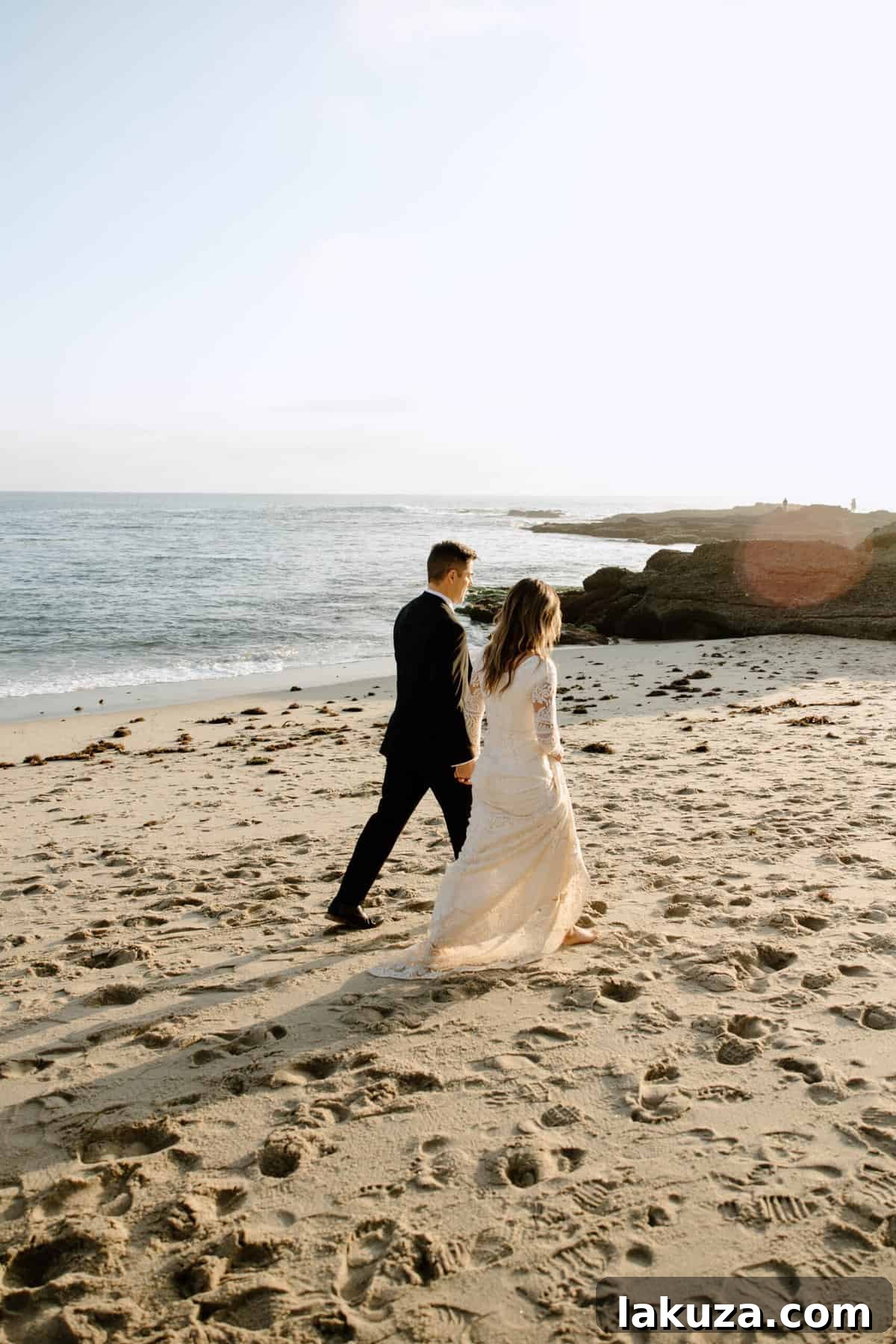 Bride Sierra walking gracefully on the beach in her wedding dress