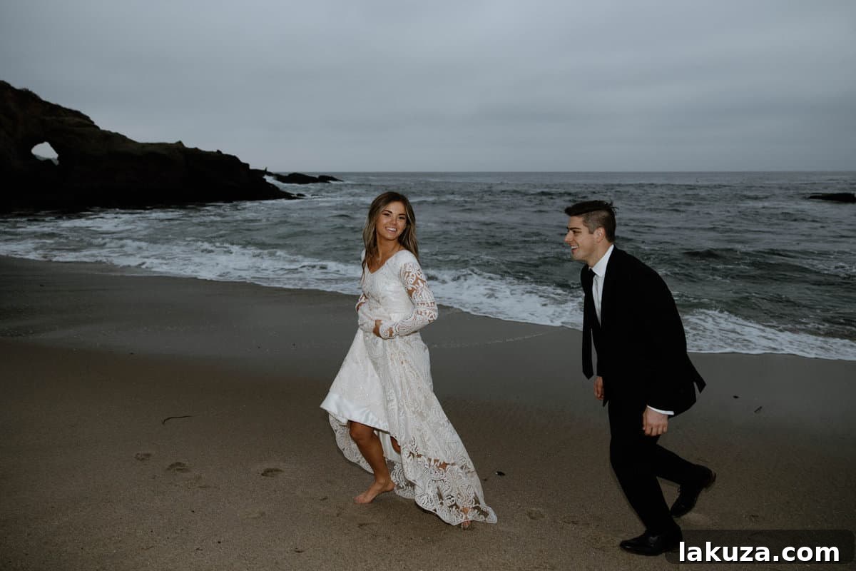 Sierra and Conner walking on the sand as the sun sets