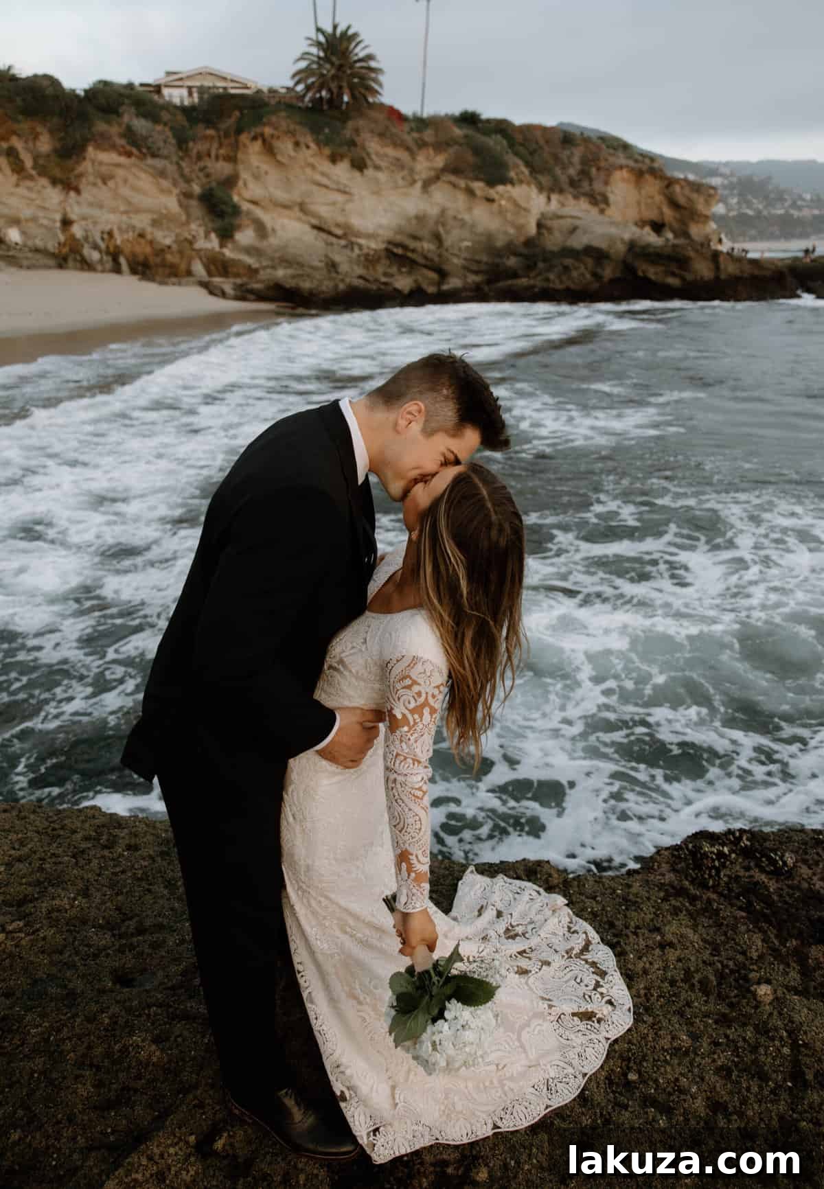 Bride and groom's silhouettes against the sunset on the beach