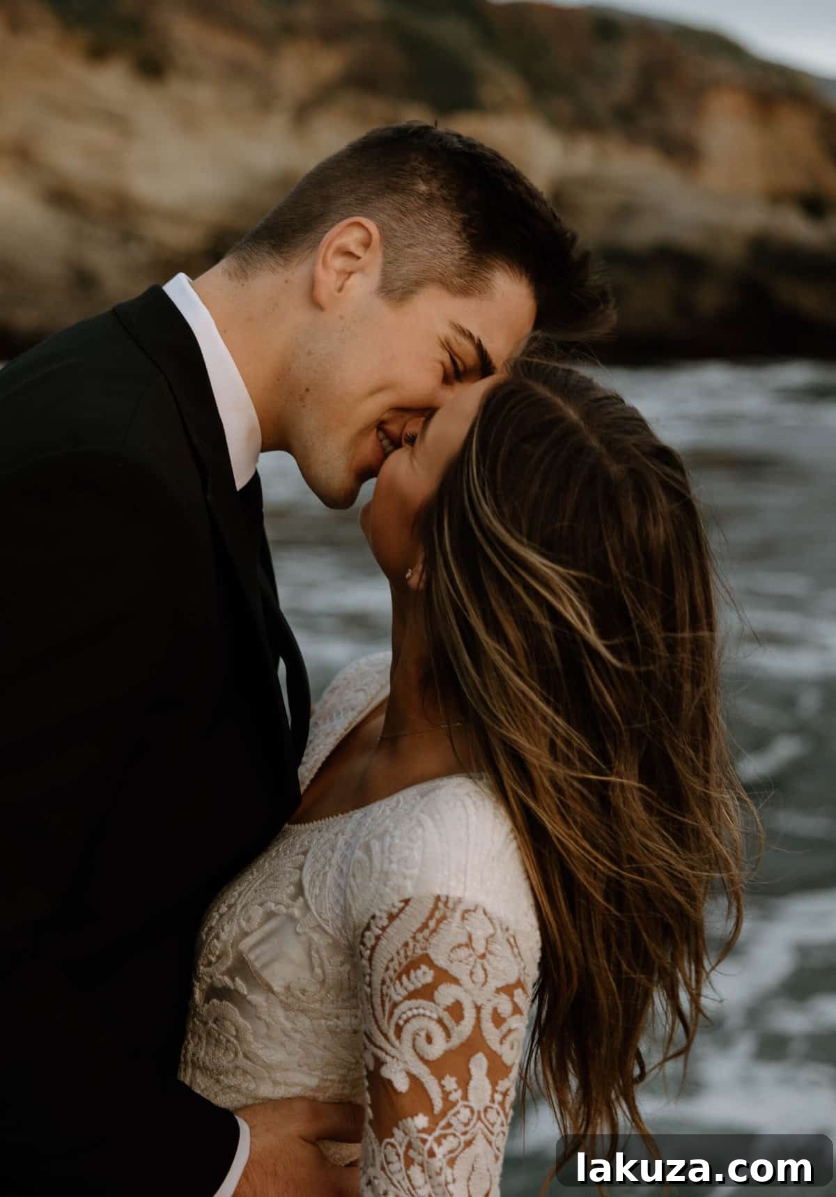 Bride and groom's gentle embrace on the sandy shore