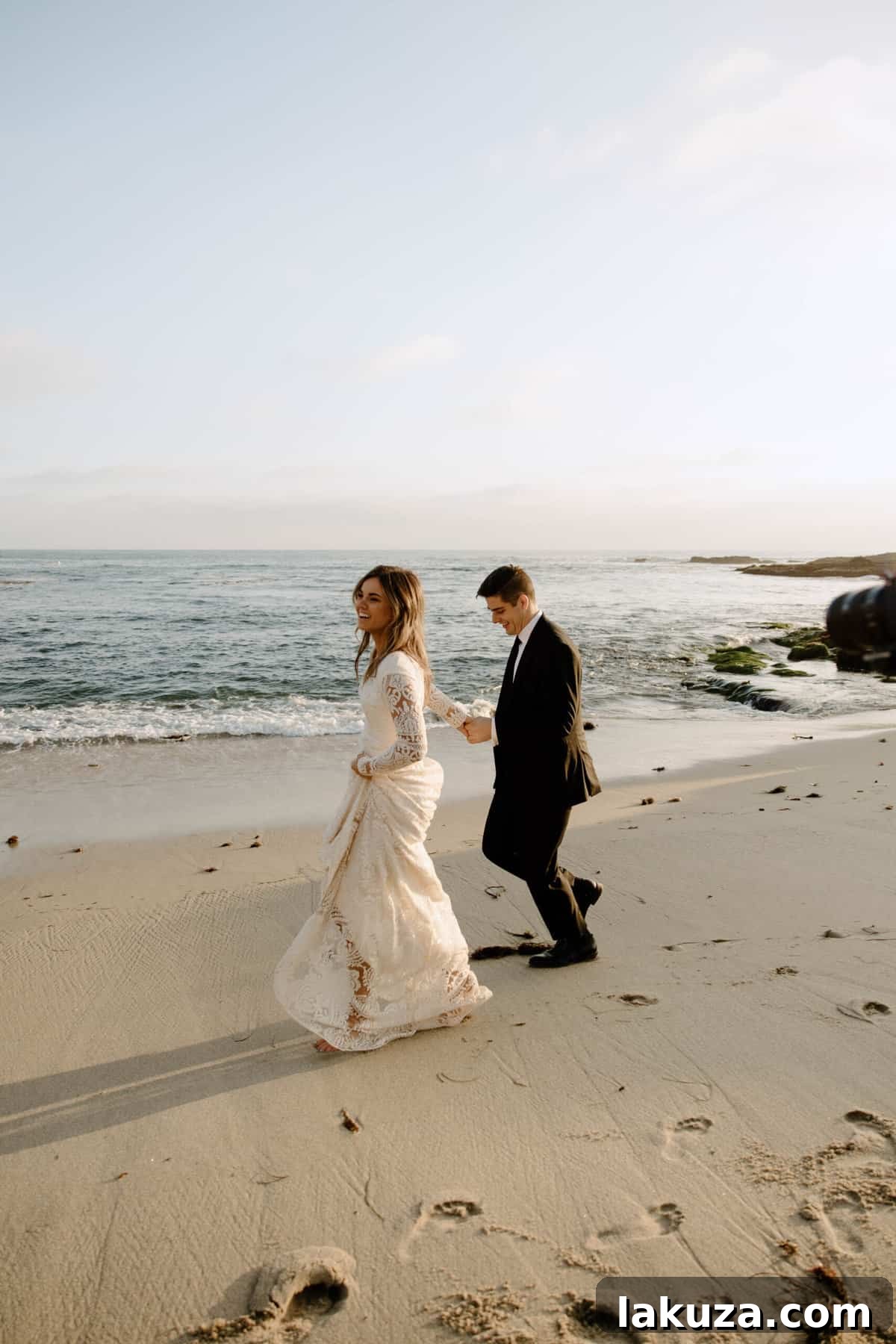 Sierra's elegant bridal train trailing on the sand