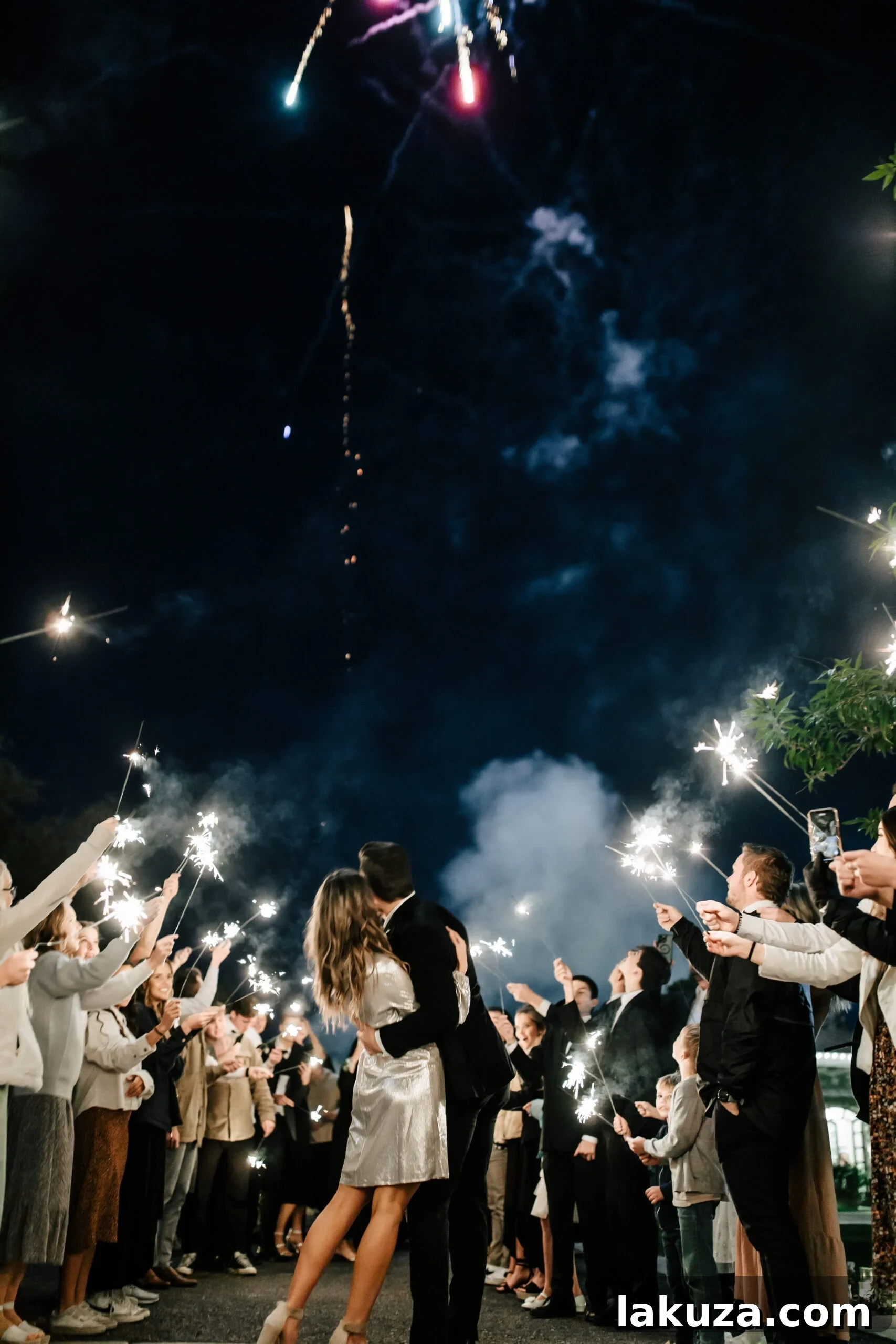 Newlyweds Sierra and Conner enjoying a sparkler send-off and surprise fireworks at their wedding reception