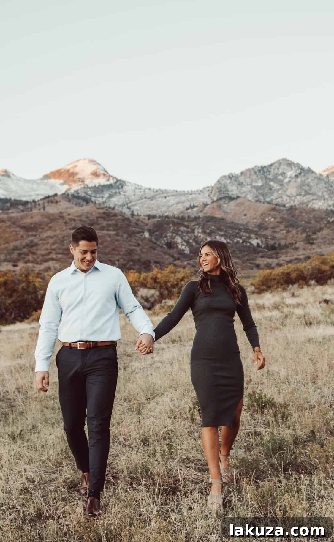 Engagement photo of couple embracing under soft lighting