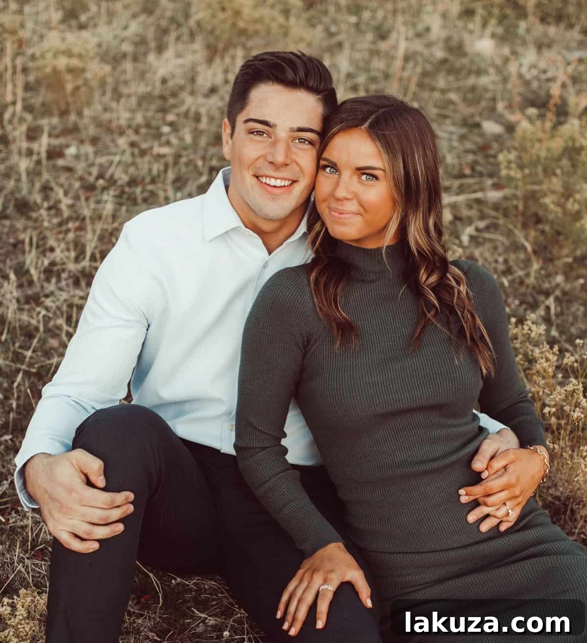 Sierra and Conner's engagement photo by a rustic fence
