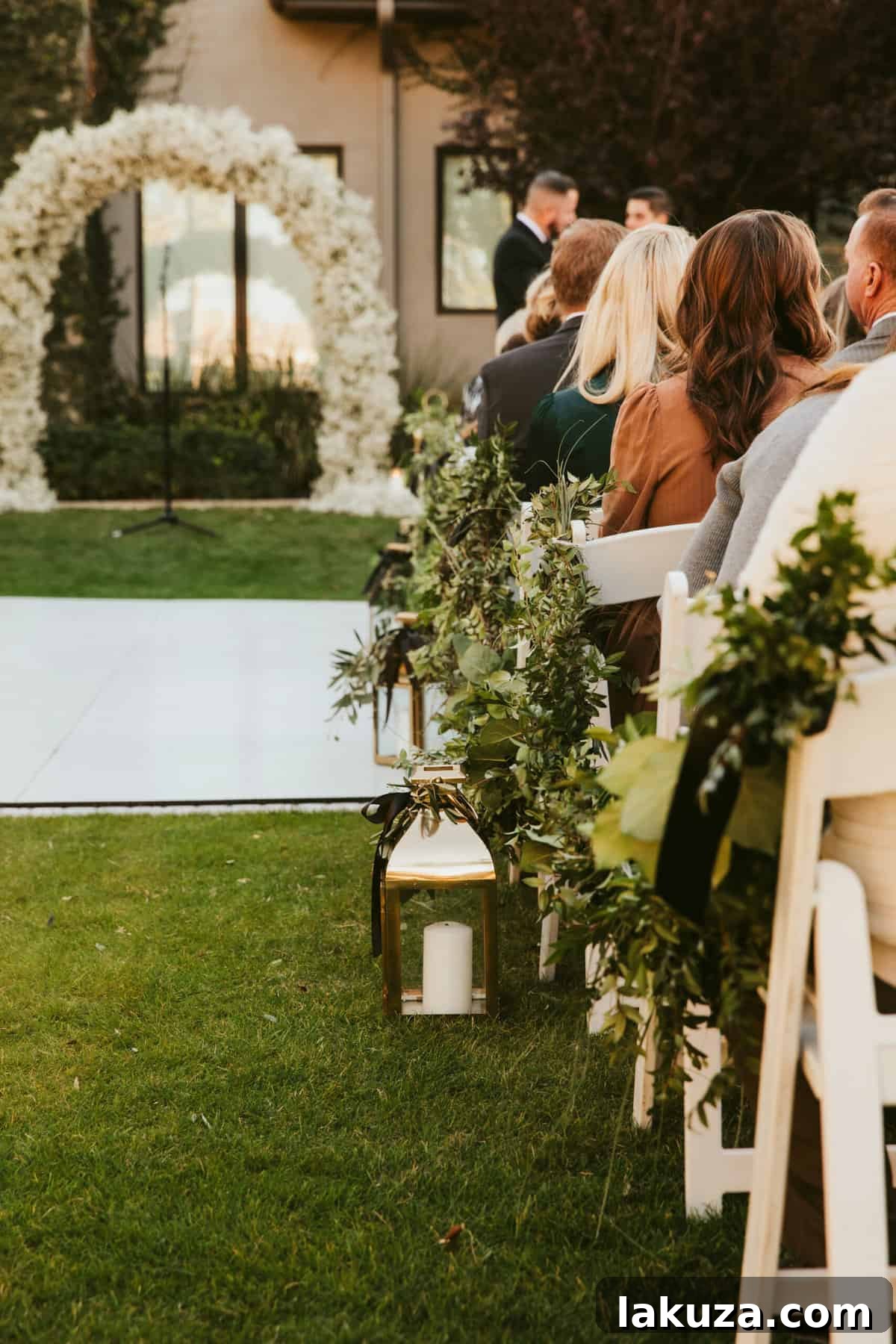 Wedding reception tables adorned with candles and delicate white flowers