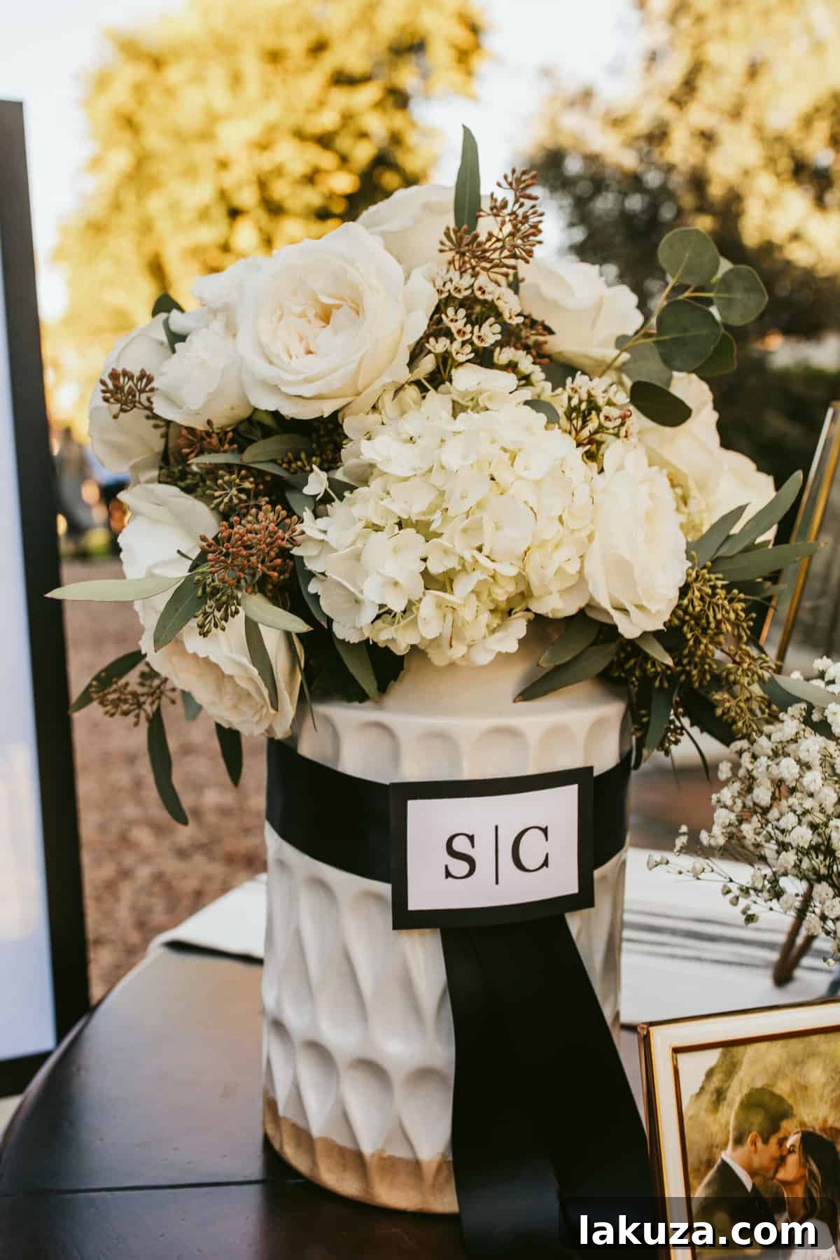 Gold lantern wedding decor with black satin ribbon