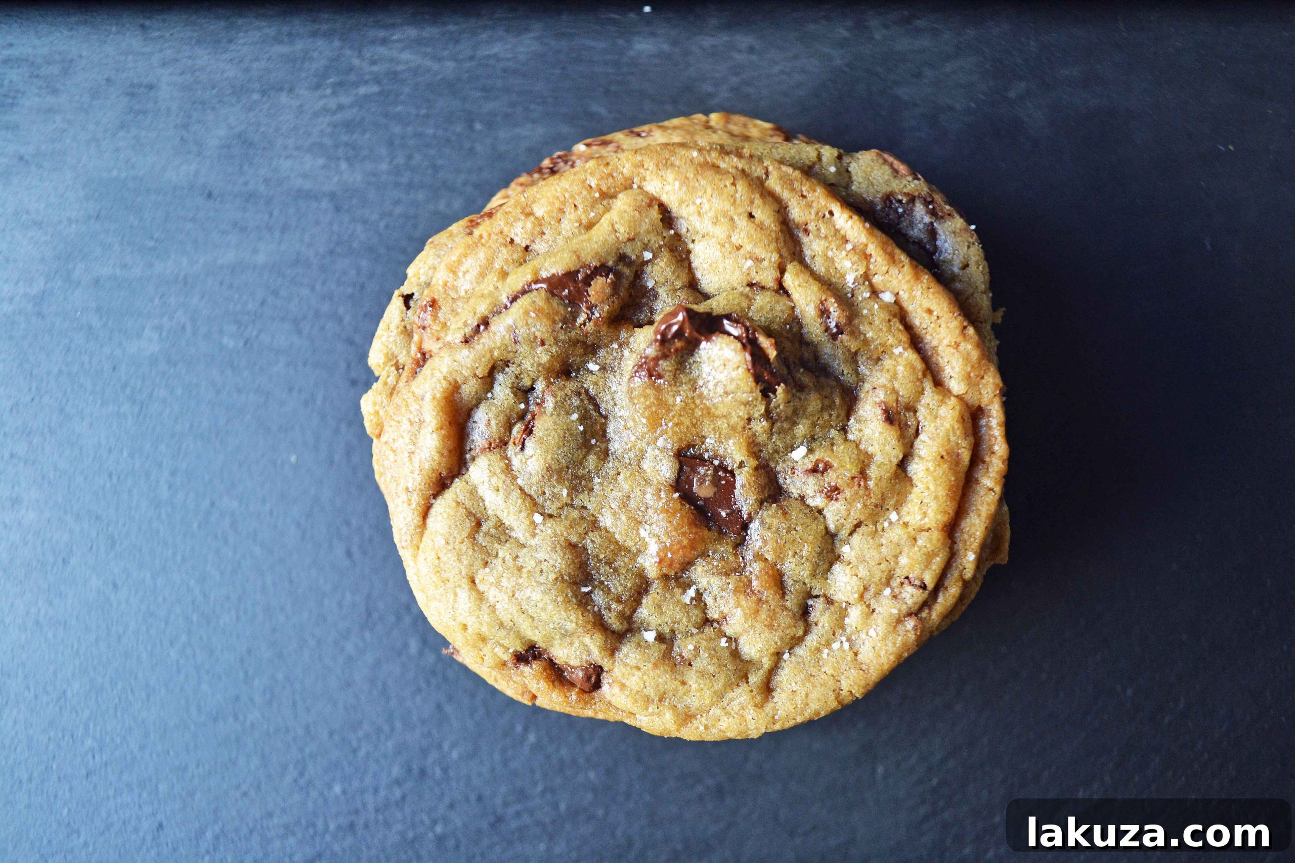 A freshly baked browned butter chocolate chip cookie with a beautifully crisp edge and soft center.
