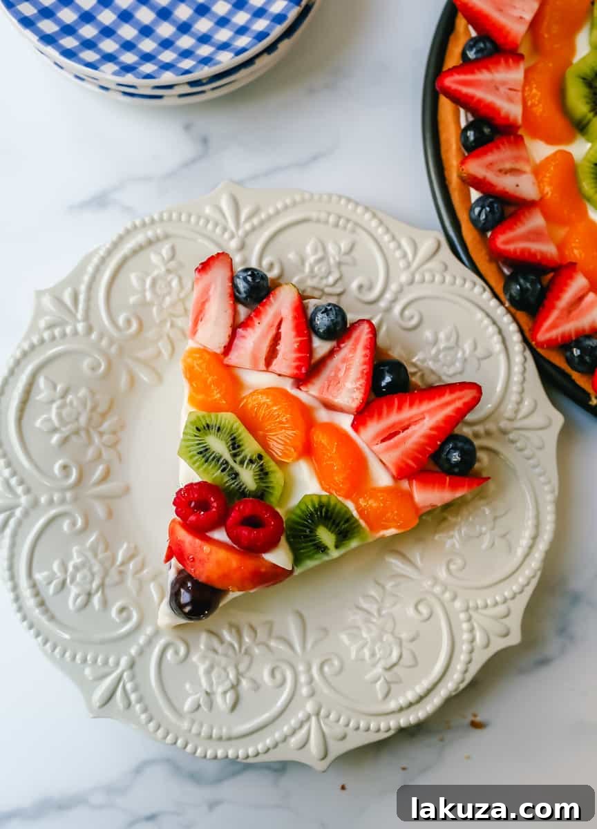 Sugar Cookie Fruit Tart 4 An overhead shot of fruit pizza with sugar cookie crust, featuring an artful arrangement of various fresh fruits.