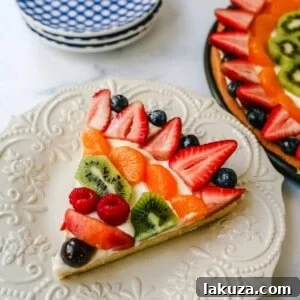 Sugar Cookie Fruit Tart 6 Fruit Pizza with a Sugar Cookie Crust is made with a large, pizza-sized baked sugar cookie and topped with a sweet cream cheese whipped cream and sprinkled with glazed fresh fruit.