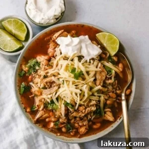 This Ranch Chicken Chili is a quick and easy soup recipe made with shredded chicken, onion, garlic, chili powder, green chilies, white beans, ranch powder, and topped with cheese and sour cream.