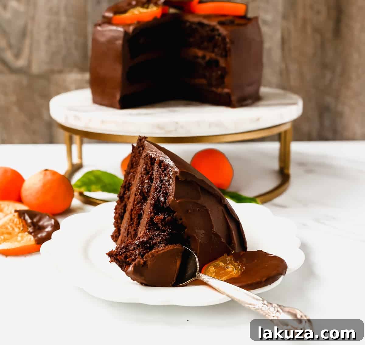 Closeup of chocolate orange cake frosting being spread with a spatula, showing its creamy texture.