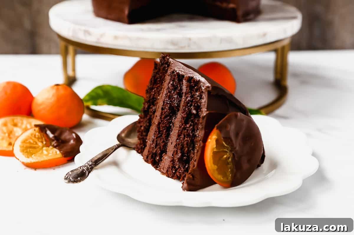 Delicious chocolate orange cake slice on a plate, ready to be enjoyed.