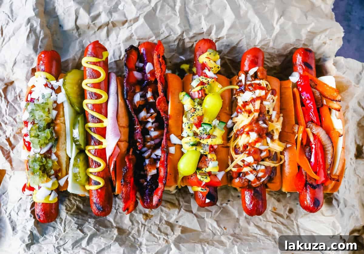An appetizing display of gourmet hot dogs, each with a unique combination of toppings like chili, cheese, and various condiments.