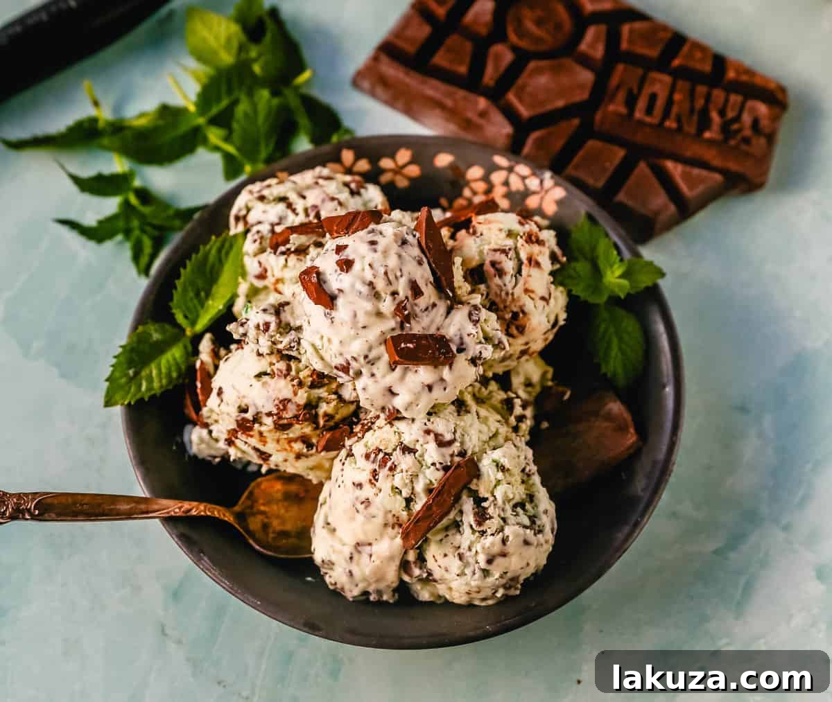 Emerald Mint Chocolate Dream 7 Mixing bowl with creamy no-churn mint chocolate chip ice cream mixture, showing whipped cream, condensed milk, and abundant chocolate pieces, ready for freezing.