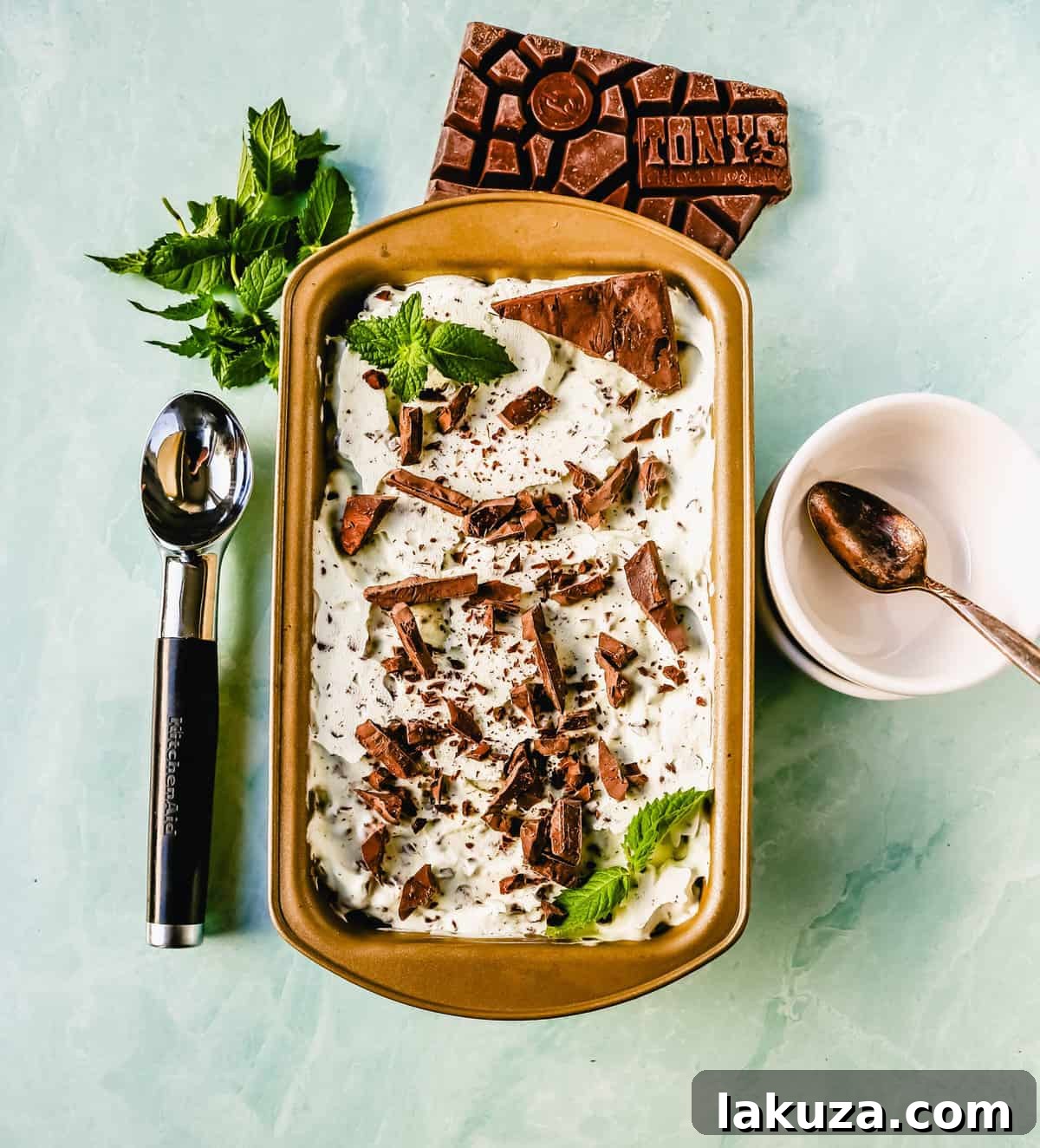 Emerald Mint Chocolate Dream 8 Freshly churned classic mint chocolate chip ice cream being scooped from an ice cream maker into a container, featuring a rich green color and plentiful chocolate chips.