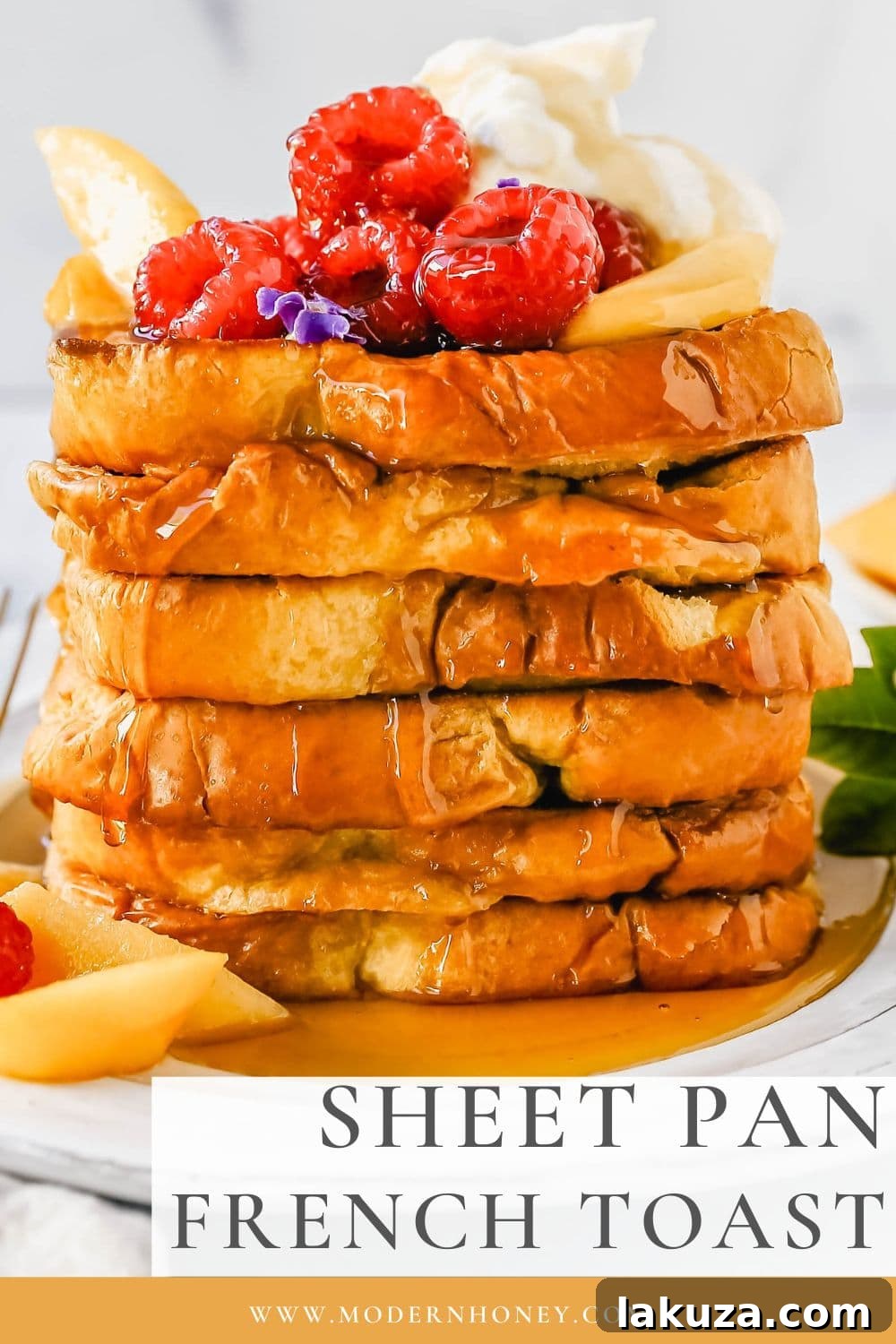 One-Pan French Toast Bake 6 Serving of Sheet Pan French Toast with a spoon of mascarpone cream and fresh berries.