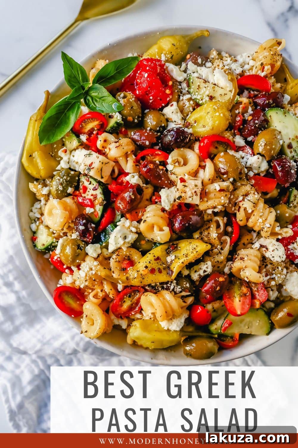 Overhead shot of a beautifully arranged Greek Pasta Salad, vibrant with fresh ingredients.