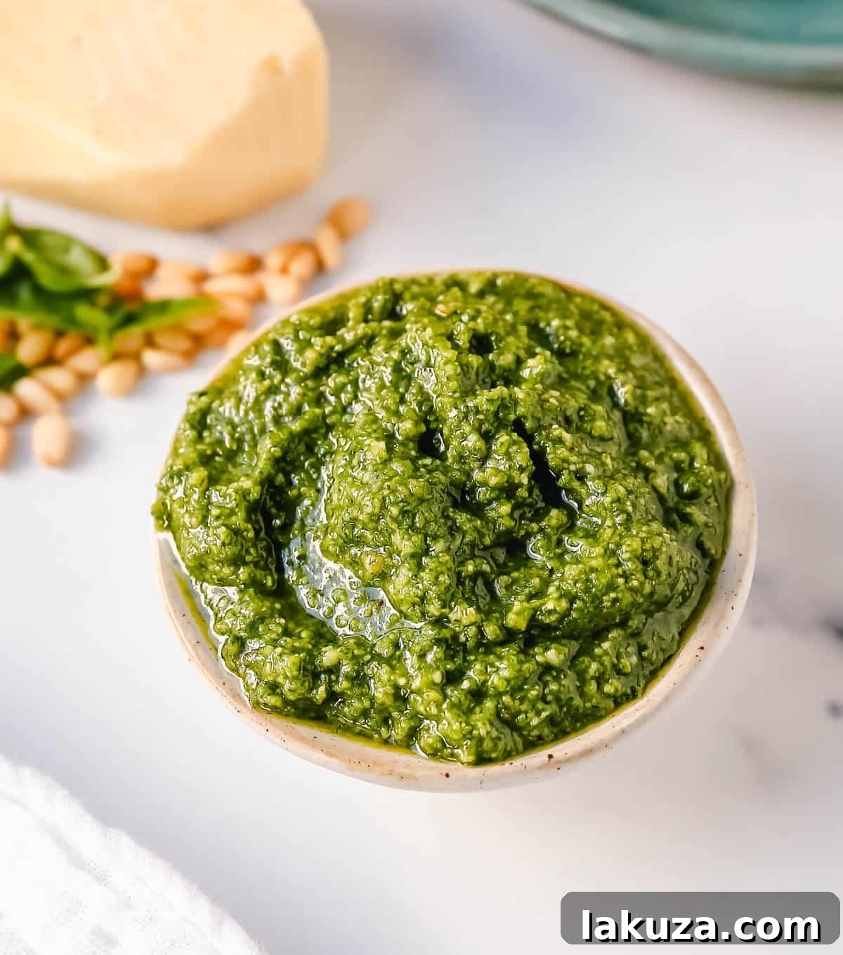 Homemade Basil Pesto Sauce made with fresh basil, extra-virgin olive oil, pine nuts, garlic, parmesan cheese, and salt and pepper. This pesto sauce is the best recipe and can be used on pasta, pizza, sandwiches, or to be used as a dip with rustic French bread.