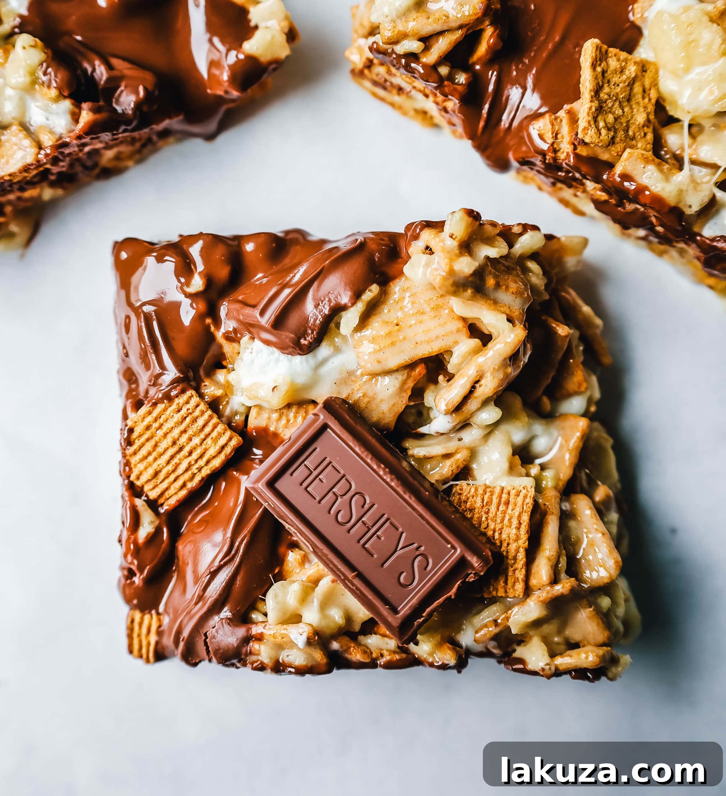 A large tray of S'more Rice Krispie Treats, showcasing the various textures and chocolate pieces, ready to be served.