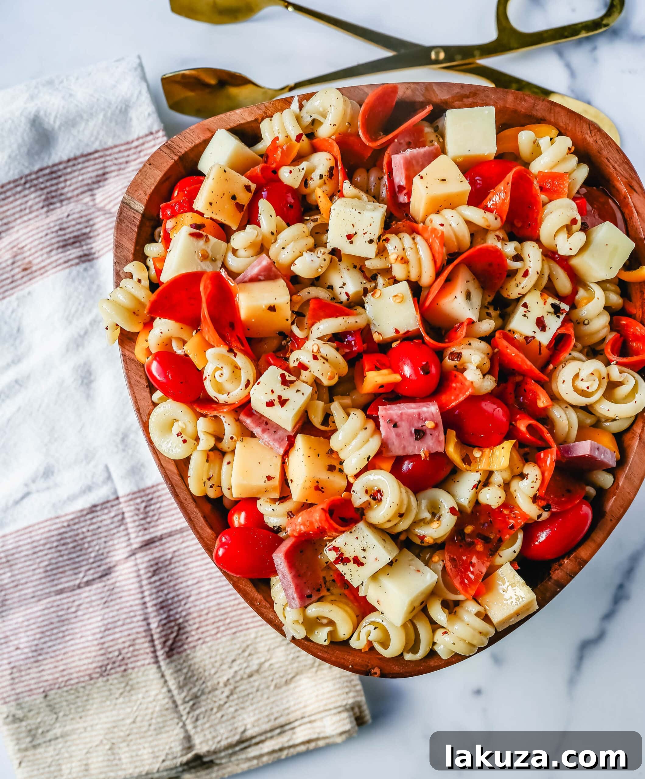 A bowl of freshly made Classic Pasta Salad, ready to be chilled